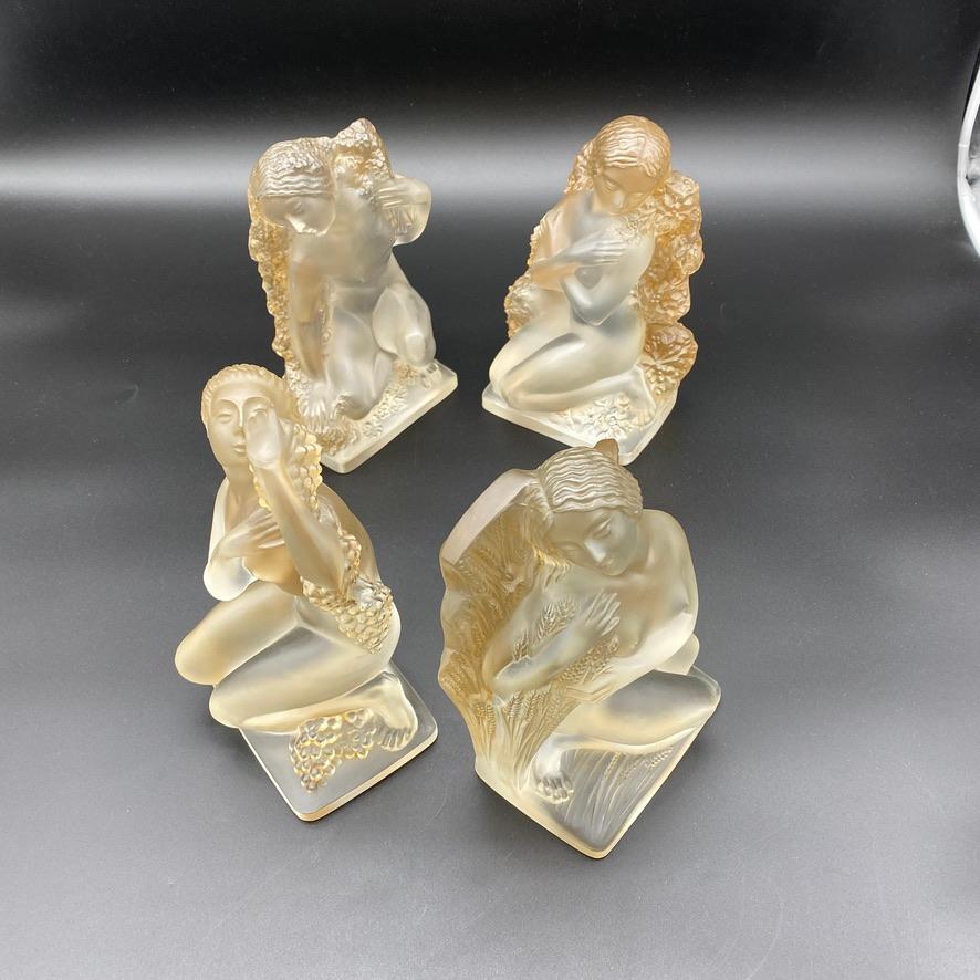   The 4 Seasons glass Statuettes were created by R.Lalique in white glass .

These examples have a brown patina and are in excellent condition.

The are all signed Lalique and or R.Lalique with a sand blasted block letters's signature