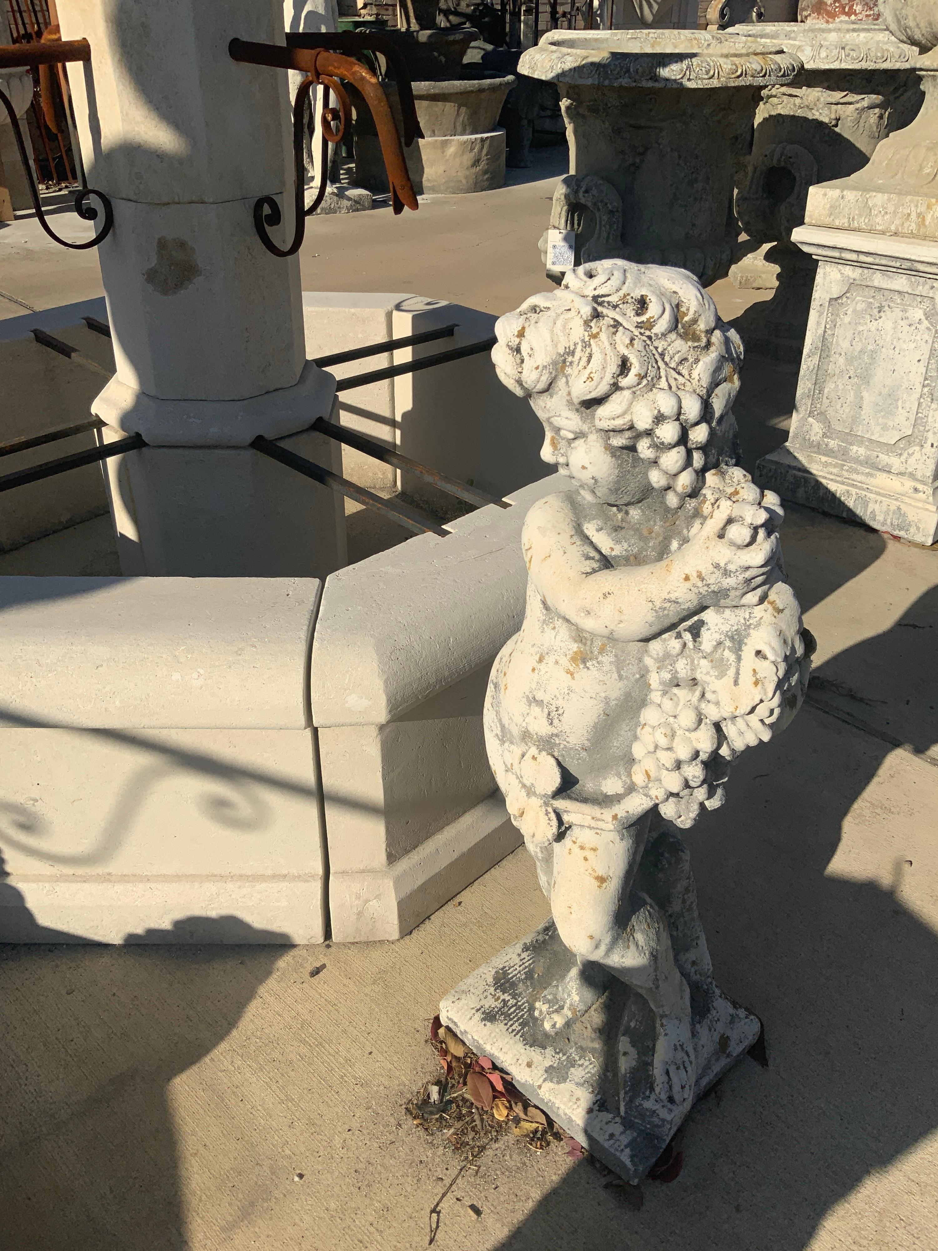 Gorgeous 4 seasons statue. Item features cherub holding grapes. Origin; France.