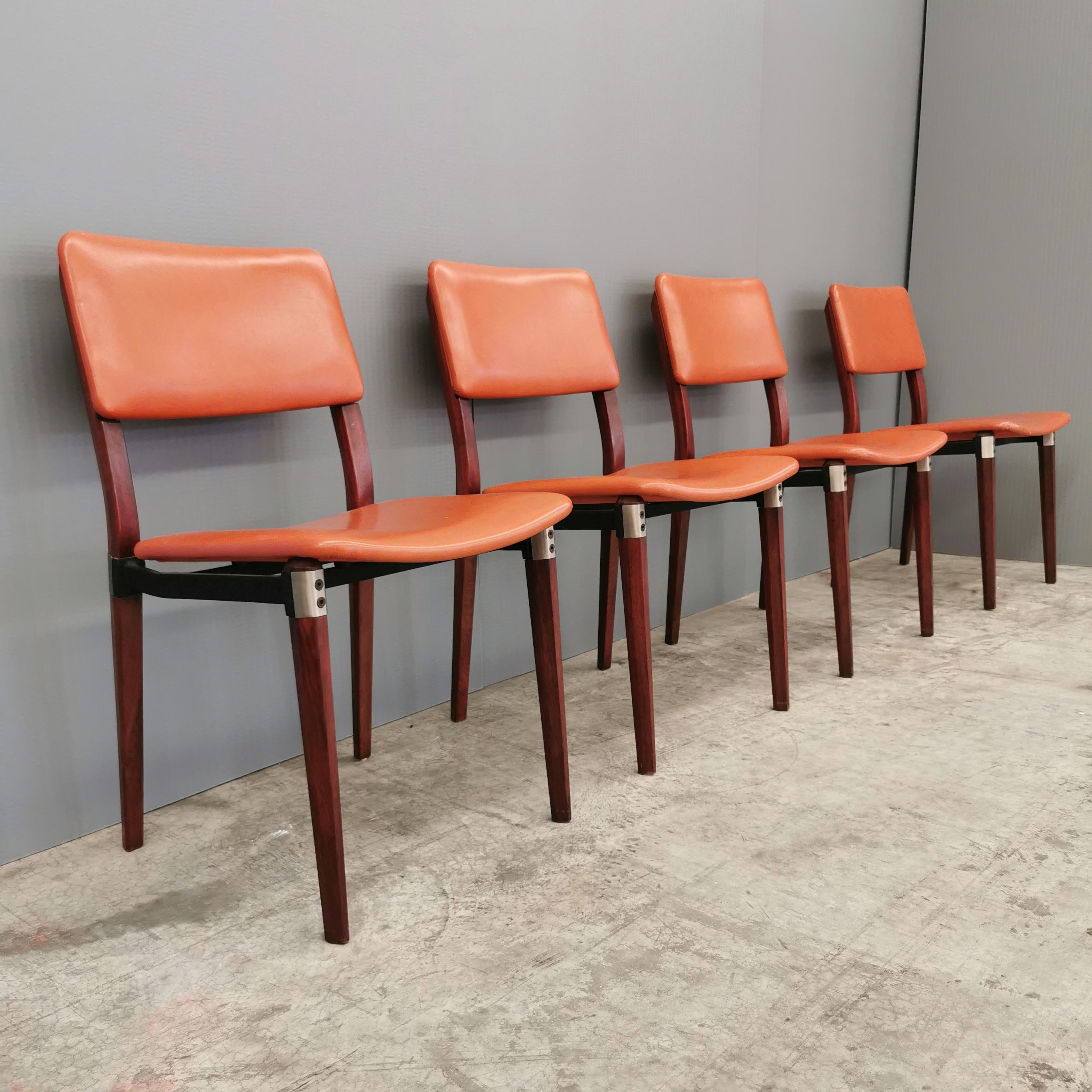 set of 4 chairs with wooden frame and leather upholstery. Designed, in the early 1960s, by Eugenio Gerli for Tecno. Very elegant and sturdy chair with steel inserts and joints. The chairs present in Excellent Condition with no scratches marks or