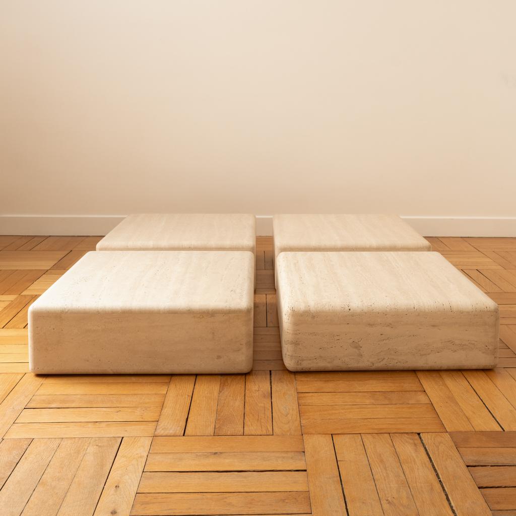 Set of four square tables that can be used as side tables, coffee tables, or end tables.
Light travertine with beautiful graining from the Tivoli quarry in Italy. Handcrafted with beautifully assembled pieces and rounded corners.

Dimensions of each