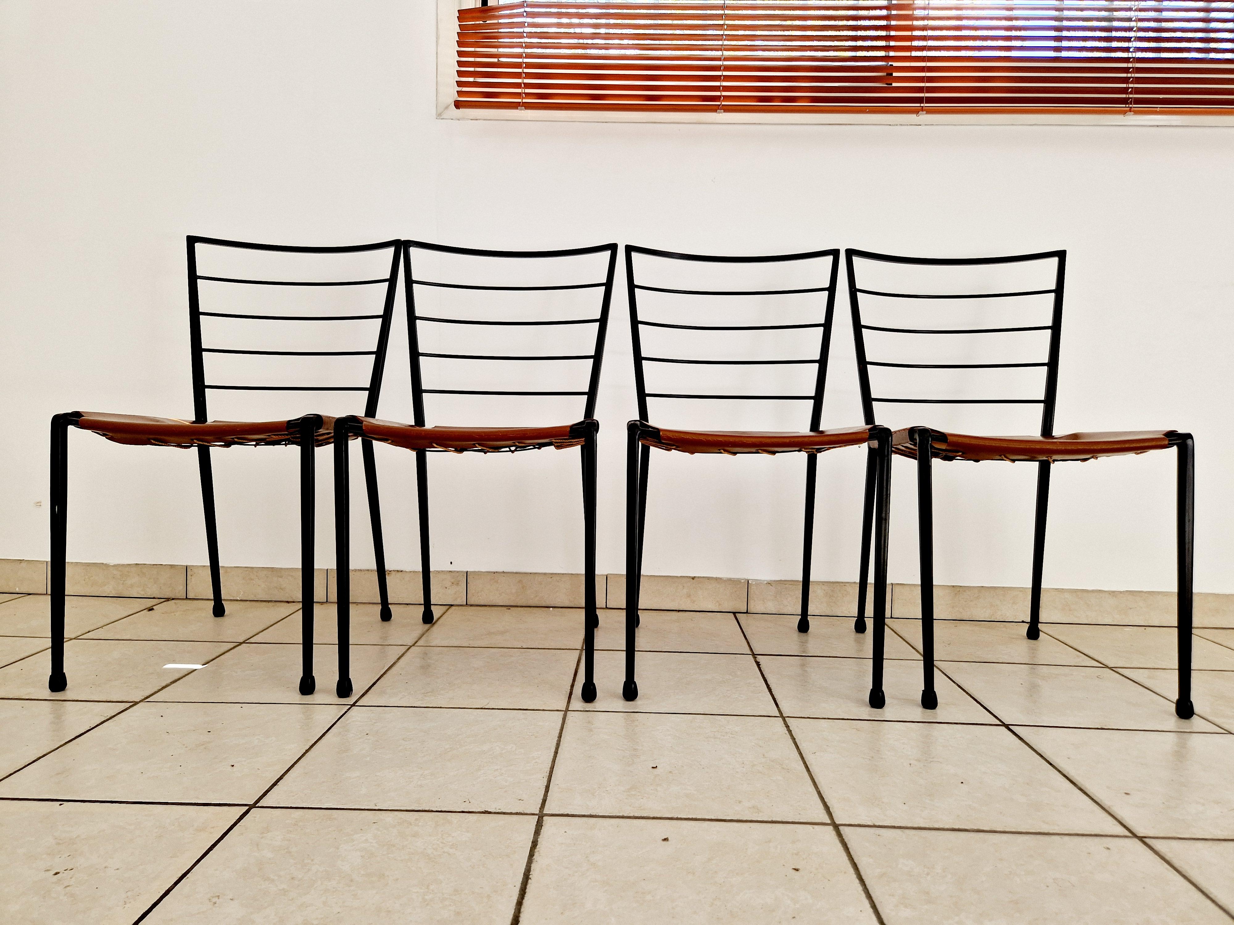 Crafted with a timeless design, these 4 Staples Ladderax dining chairs by Robert Heal embody the essence of Mid-Century Modernism. Each chair stands as a genuine piece from the 1960s, showcasing a solid leather upholstery and a robust metal frame