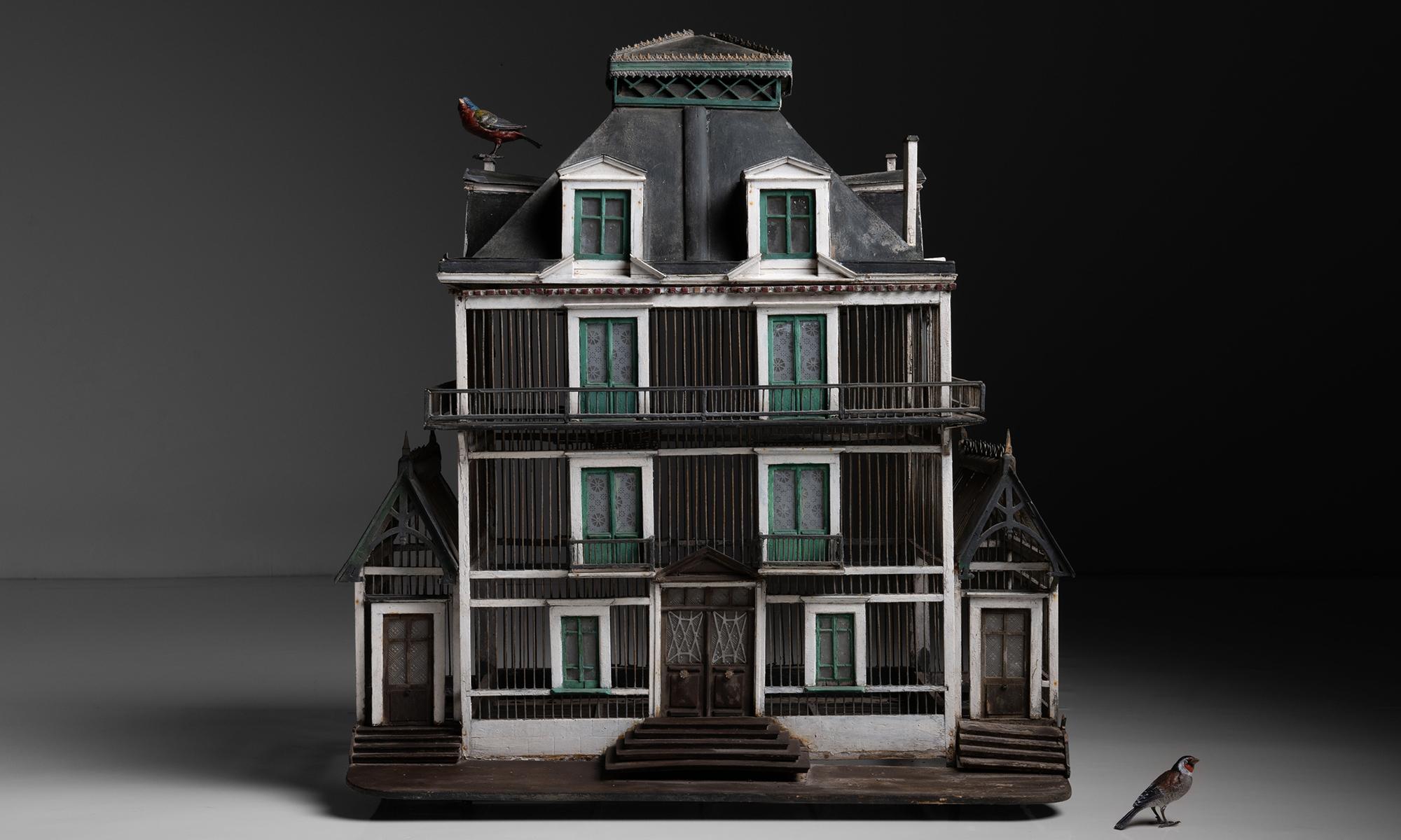 4 Story Bird Cage

France, circa 1860

Incredible birdcage with glass windows, door, balconies and porticoes.

Measures 31.5”w x 22.5”d x 36”h