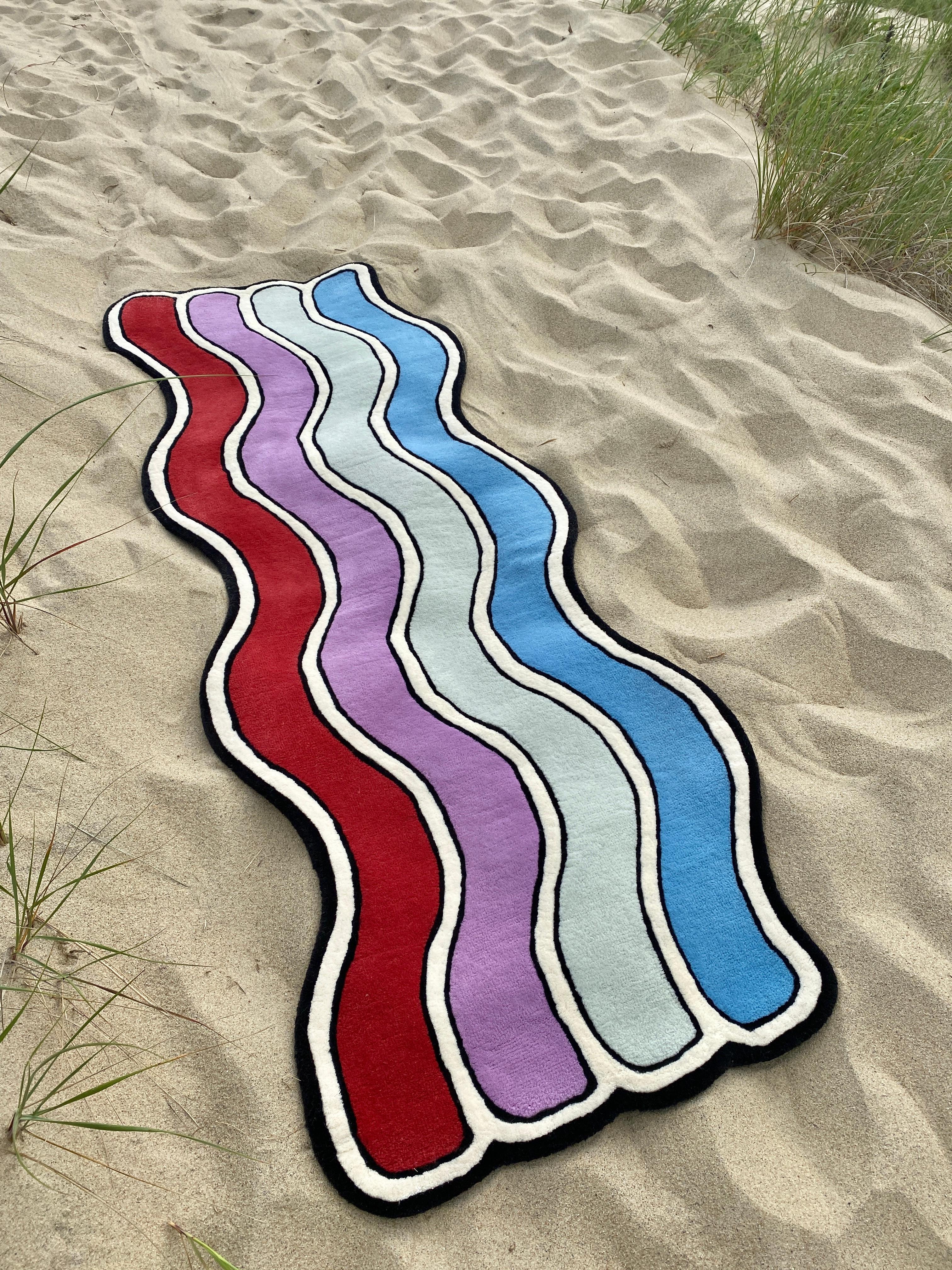 The ?Wavy Rug? is a series of rugs first exhibited in our ?Pieces Homes ?Project in Kennebunk, Maine. The Wavy Rug design concept started as a single rug composed of 10 multi-colored, undulating stripes. From there we imagined how “snippets” of the