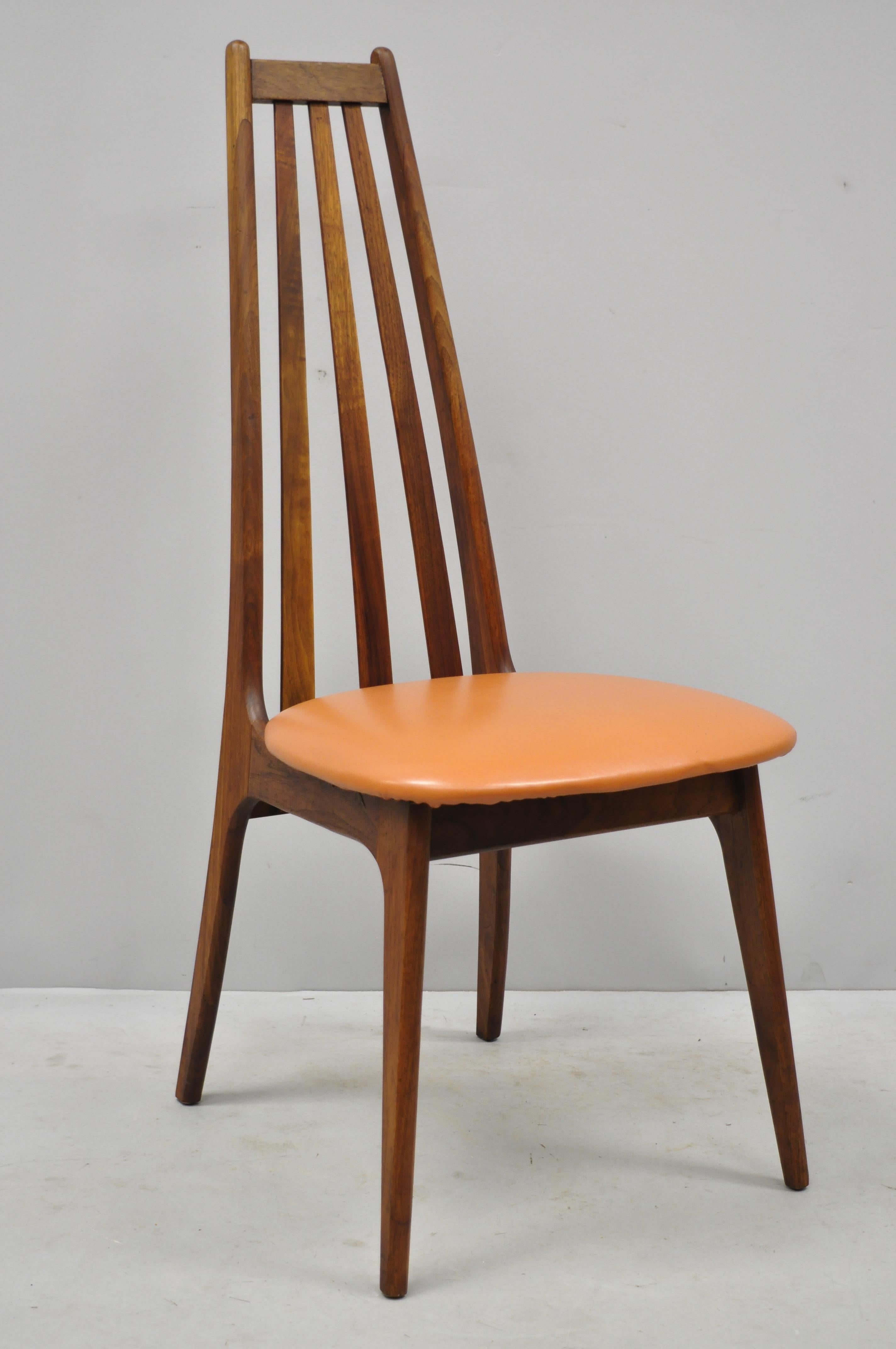 4 tall back vintage Danish modern teak wood dining chairs after Adrian Pearsall. Listing features (4) side chairs, tall backs, solid wood construction, beautiful wood grain, tapered legs, clean modernist lines, circa 1960. Measurements: 42.5