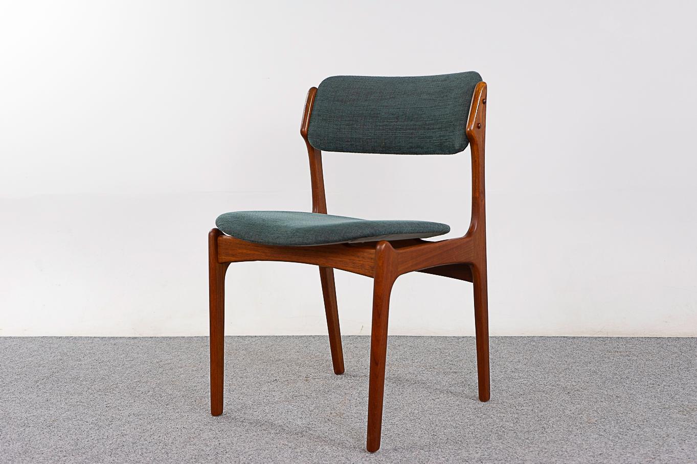 Teak Model 49 dining chairs by Erik Buch, circa 1960's. Beautifully curved backrests and generous seat design provide support and comfort. Solid wood frame with cross braces for added stability and support. Floating seat design adds an air of