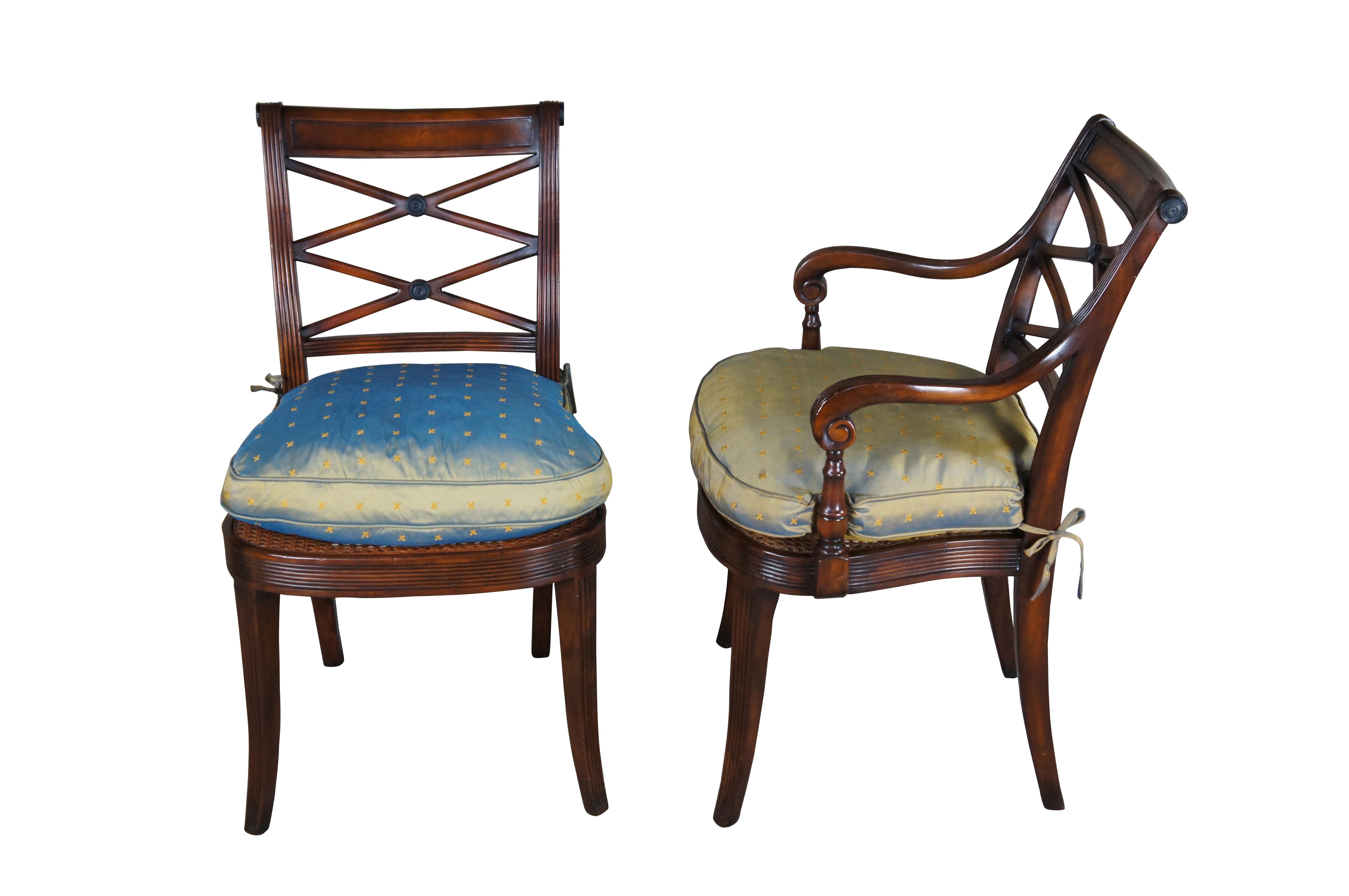 Theodore Alexander 4100. A hand carved armchair with reeded decoration, the over scroll and double 'X' pierced back above a cane seat with upholstered downfilled cushion. The chairs are made from mahogany and feature sabre legs.

Dimensions:
20