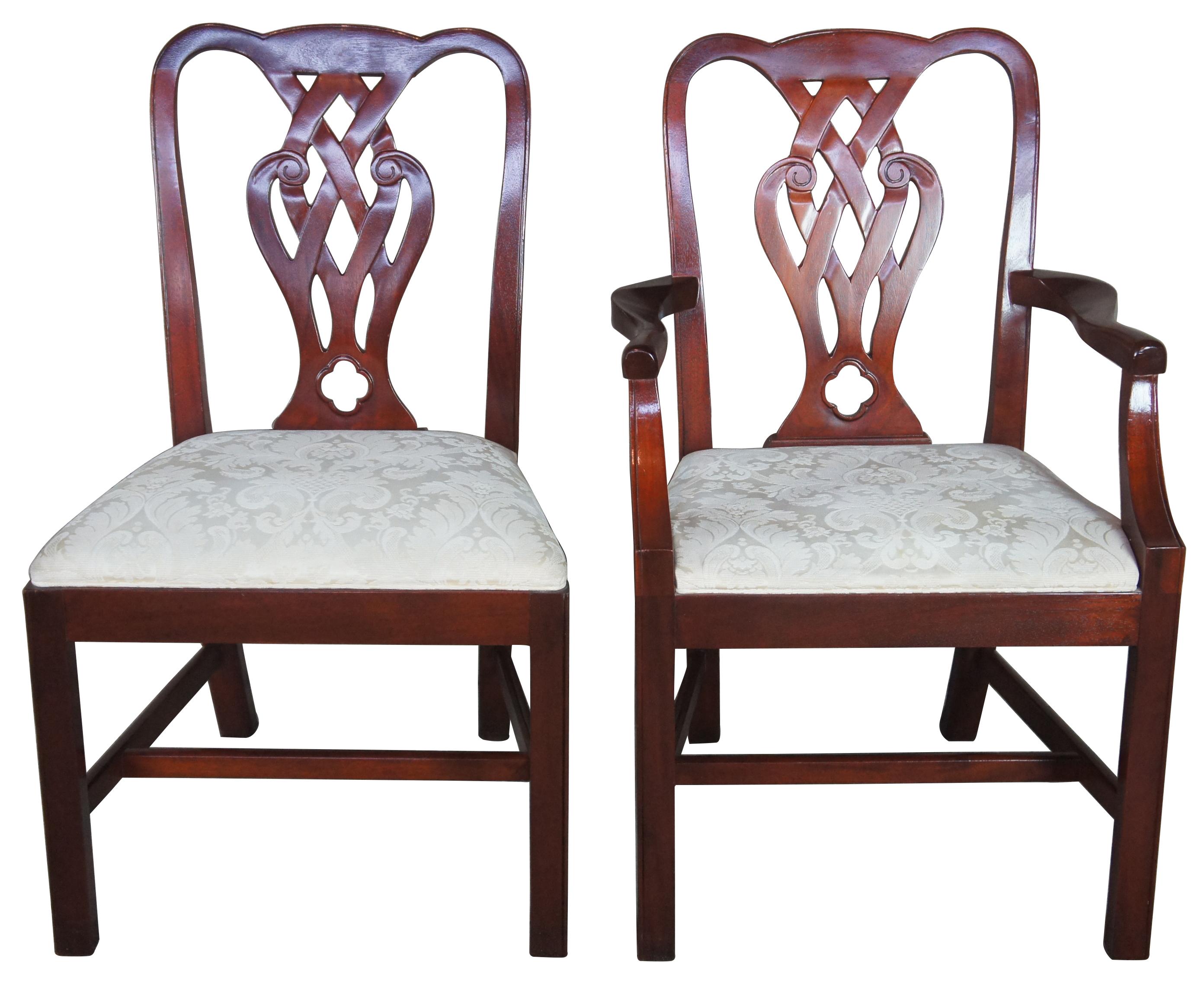 Baker dining chairs, circa 1980s. Made from mahogany with an interwoven pierced and carved back. Features a brocade upholstered white seat. Includes 2 arms and 2 sides.
    