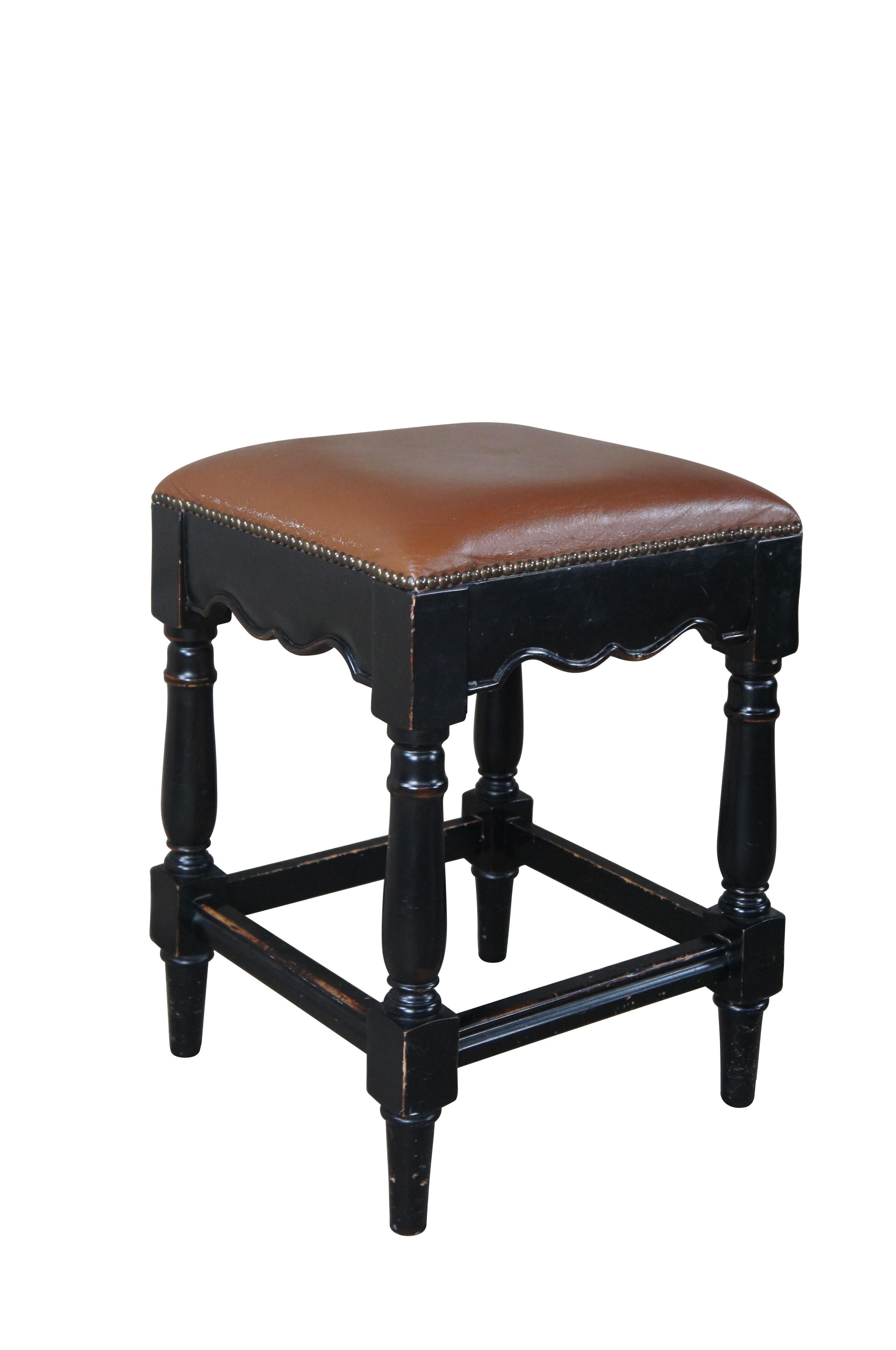 Four vintage Ballard Designs Marlow low bar or counter height stools featuring French Country styling with ebonized frame, leather seats and brass nailhead trim.  Distributed by Hillsdale Furniture inc.

Dimensions:
16