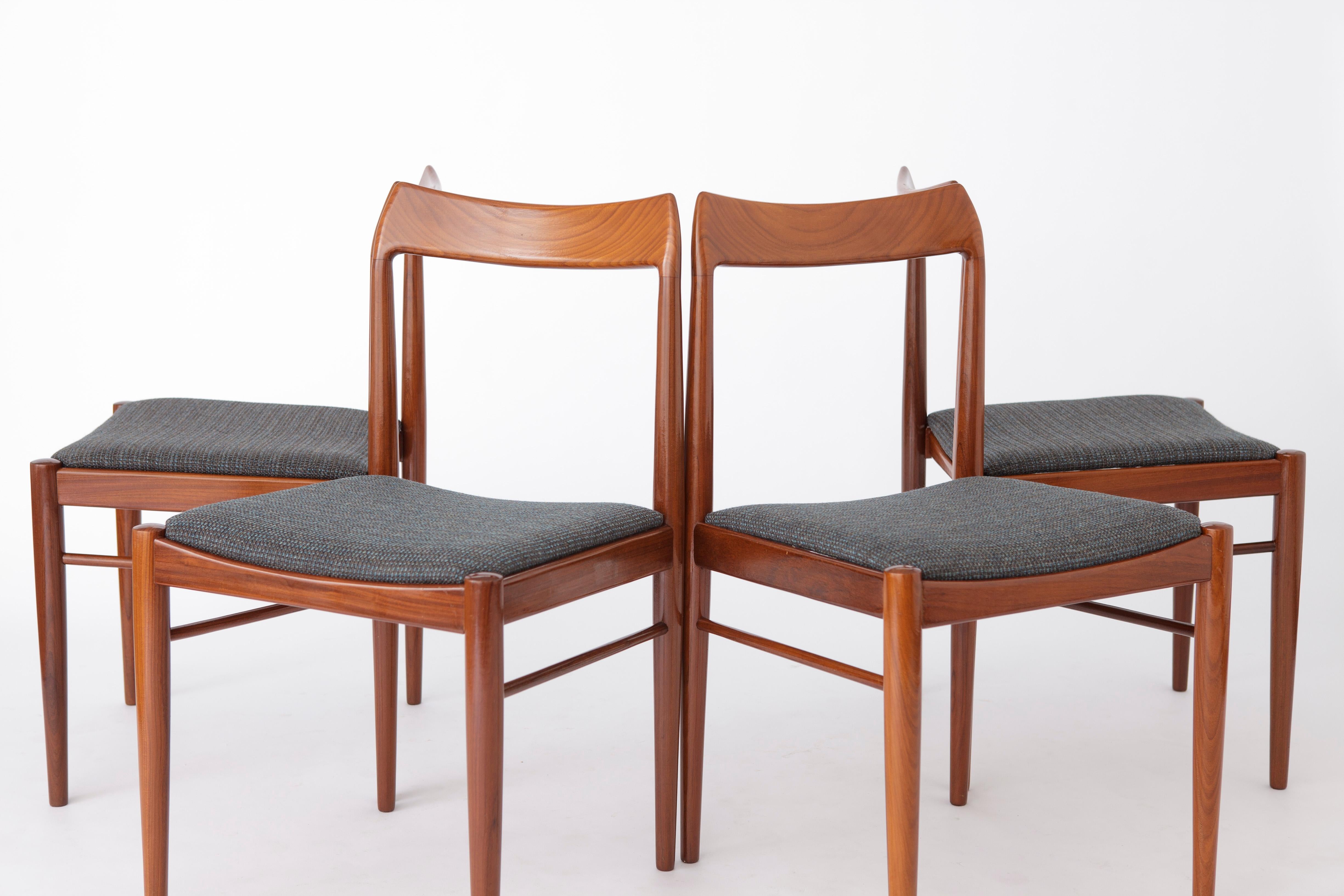 Set of 4 teak dining chairs. Unknown manufacturer. 
Origin: most likely Germany. 
Displayed price is for a set of 4. 

Sturdy teak wood chair frames. Refurbished and oiled. 
Reupholstered with light grey textile cover. 