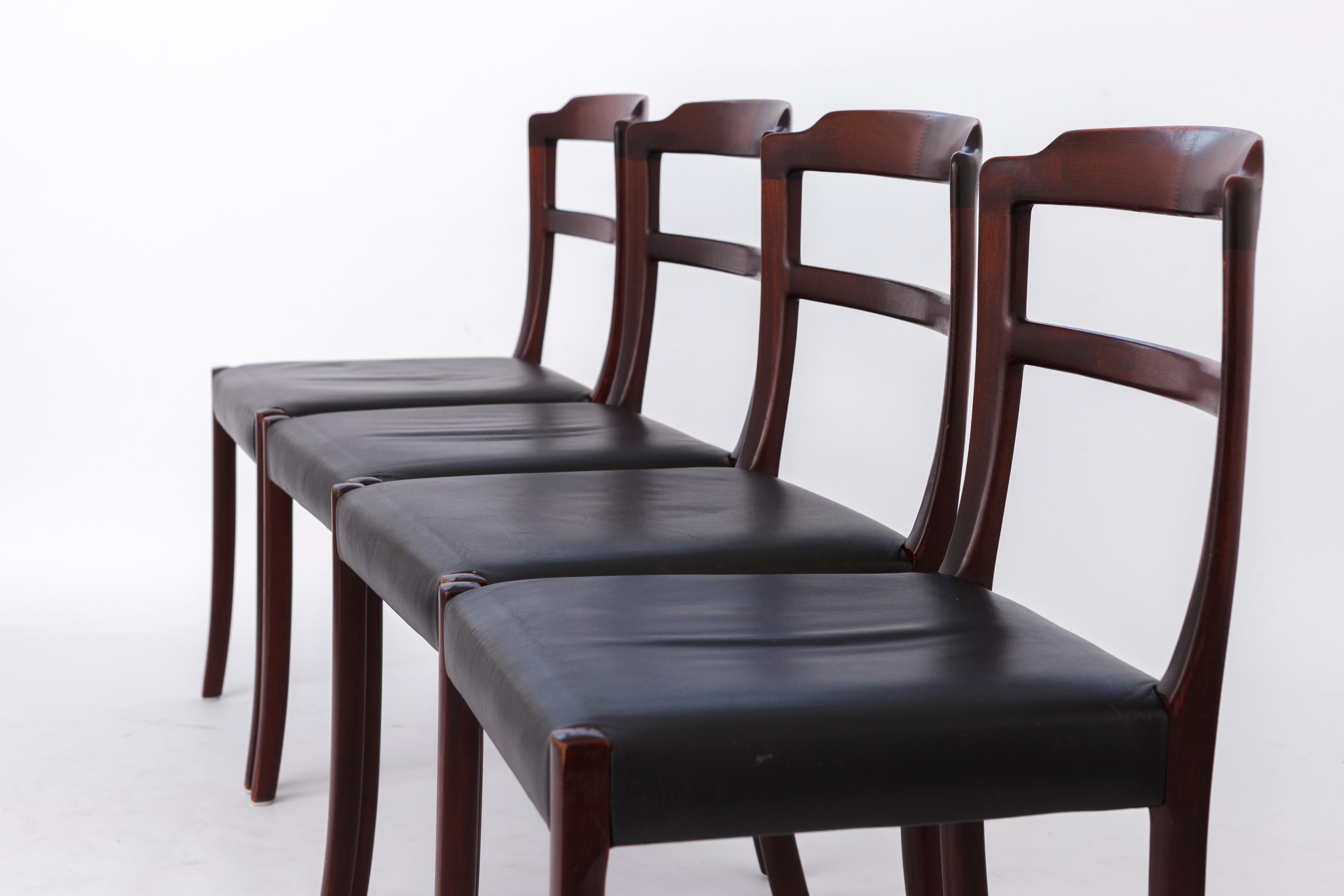 Set of 4 dining chairs by Ole Wanscher, Denmark.
Production period: 1960s. 
Displayed price is for 4 chairs. 

Good vintage condition. 
Sturdy rosewood frames. Refurbished and oiled. 
Original black leather seat cover. 
