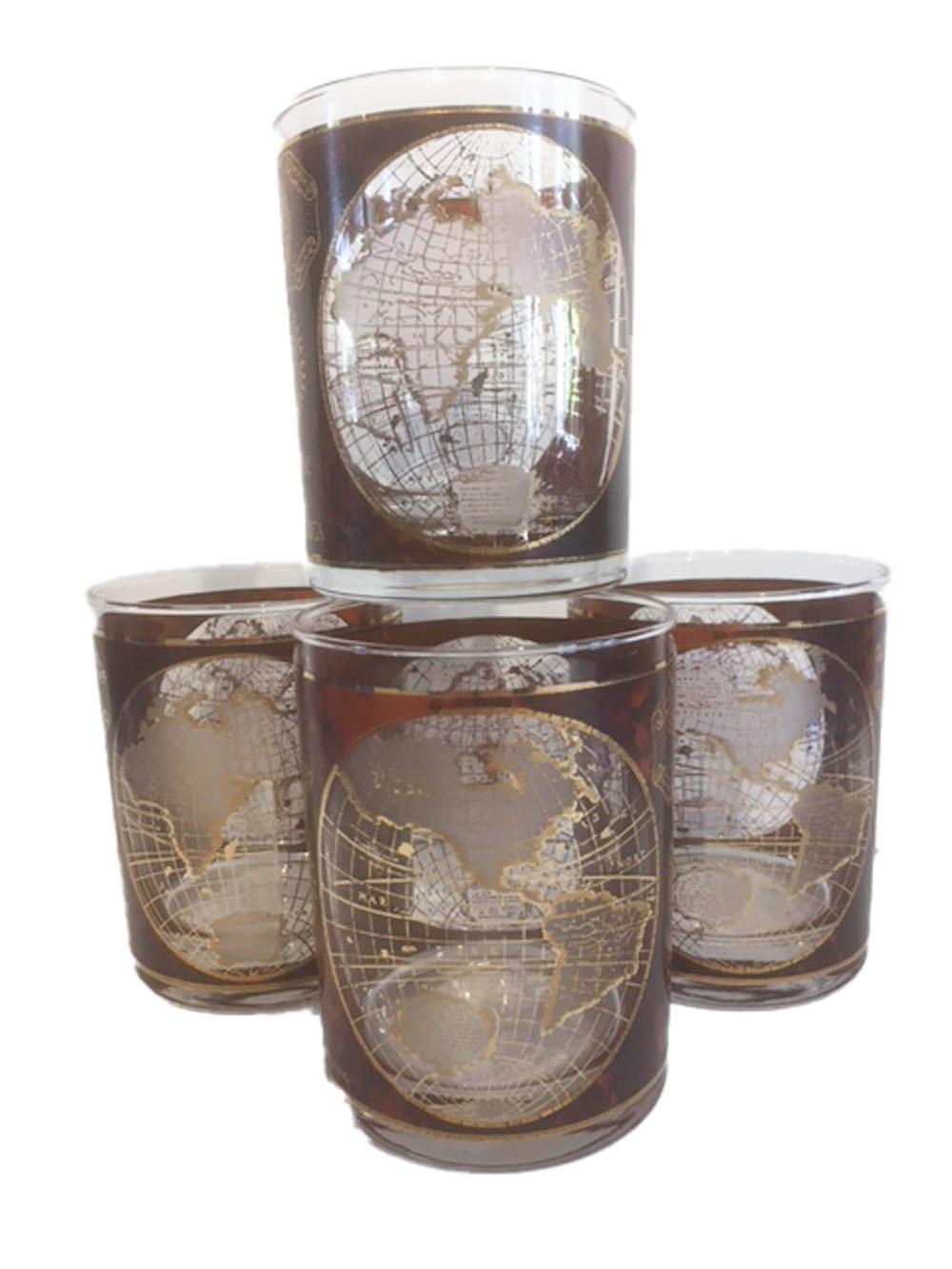 Vintage set of 4 Culver, LTD. large rocks glasses with open fields on a simulated leather background, the open fields decorated with old world maps of the eastern and western hemispheres. The sides decorated with map and sun images along with the