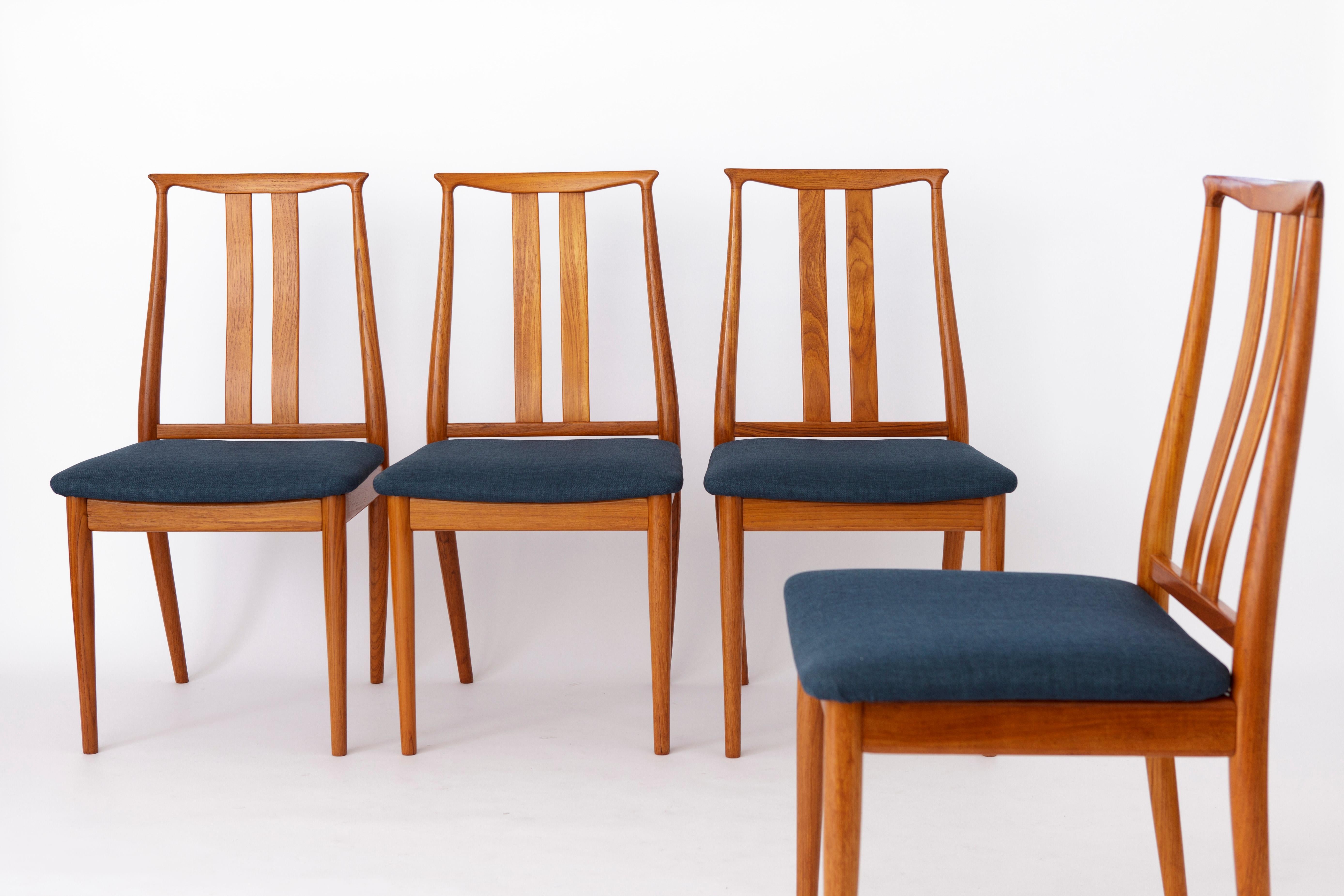 Set of 4 Danish vintage chairs from the 1960s. 
Manufacturer: Overseas Furniture A/S
Displayed price is for a set of 4. 

Sturdy teak wood chair frames. Refurbished and oiled. 
Reupholstered with dark blue textile cover. 
Manufacturer's mark under