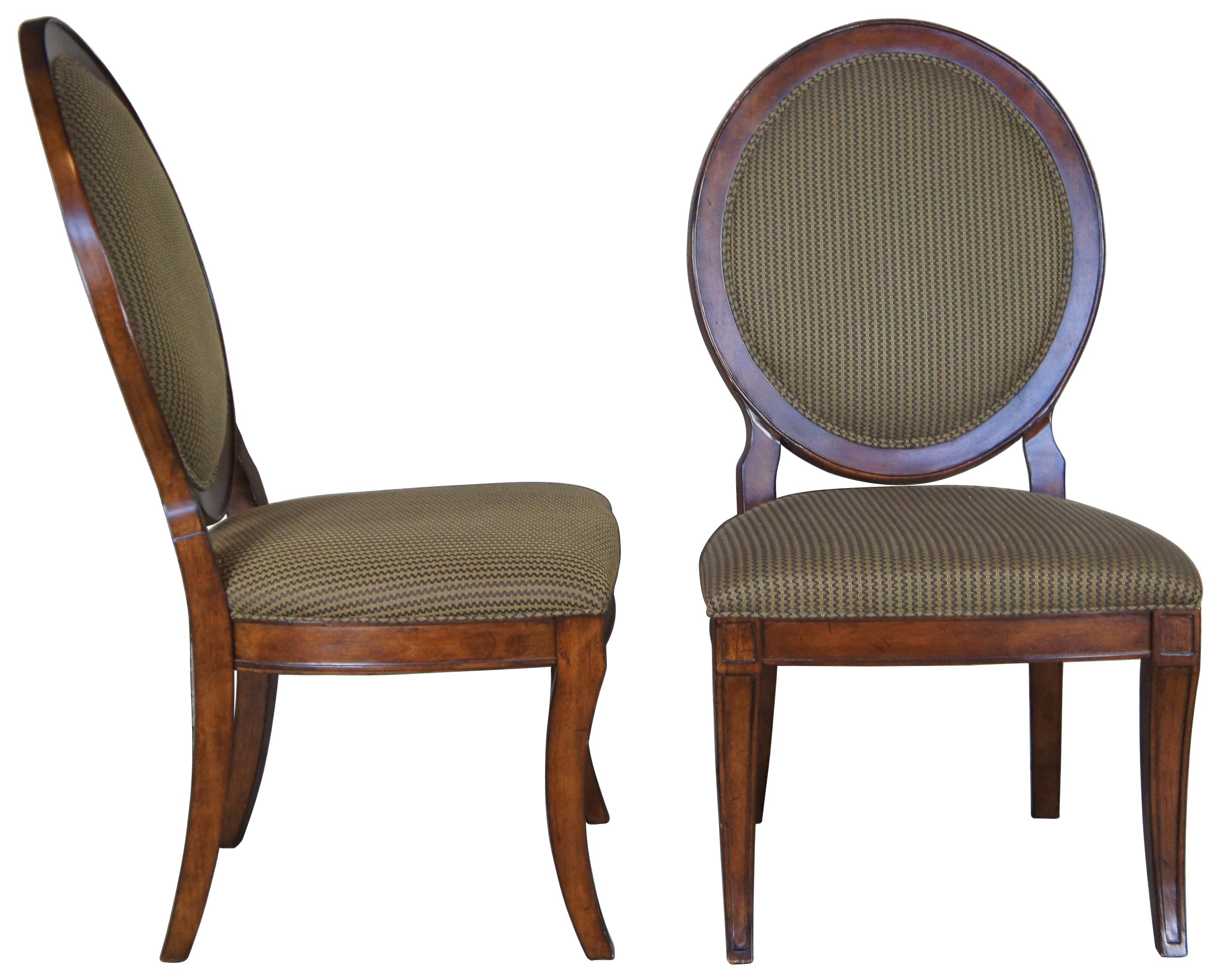 Set of four vintage Drexel Heritage Savoy collection dining chairs. Featuring a rounded oval wheel back design with exposed back support inspired by architecture and furniture designs of Louis XVI.
 