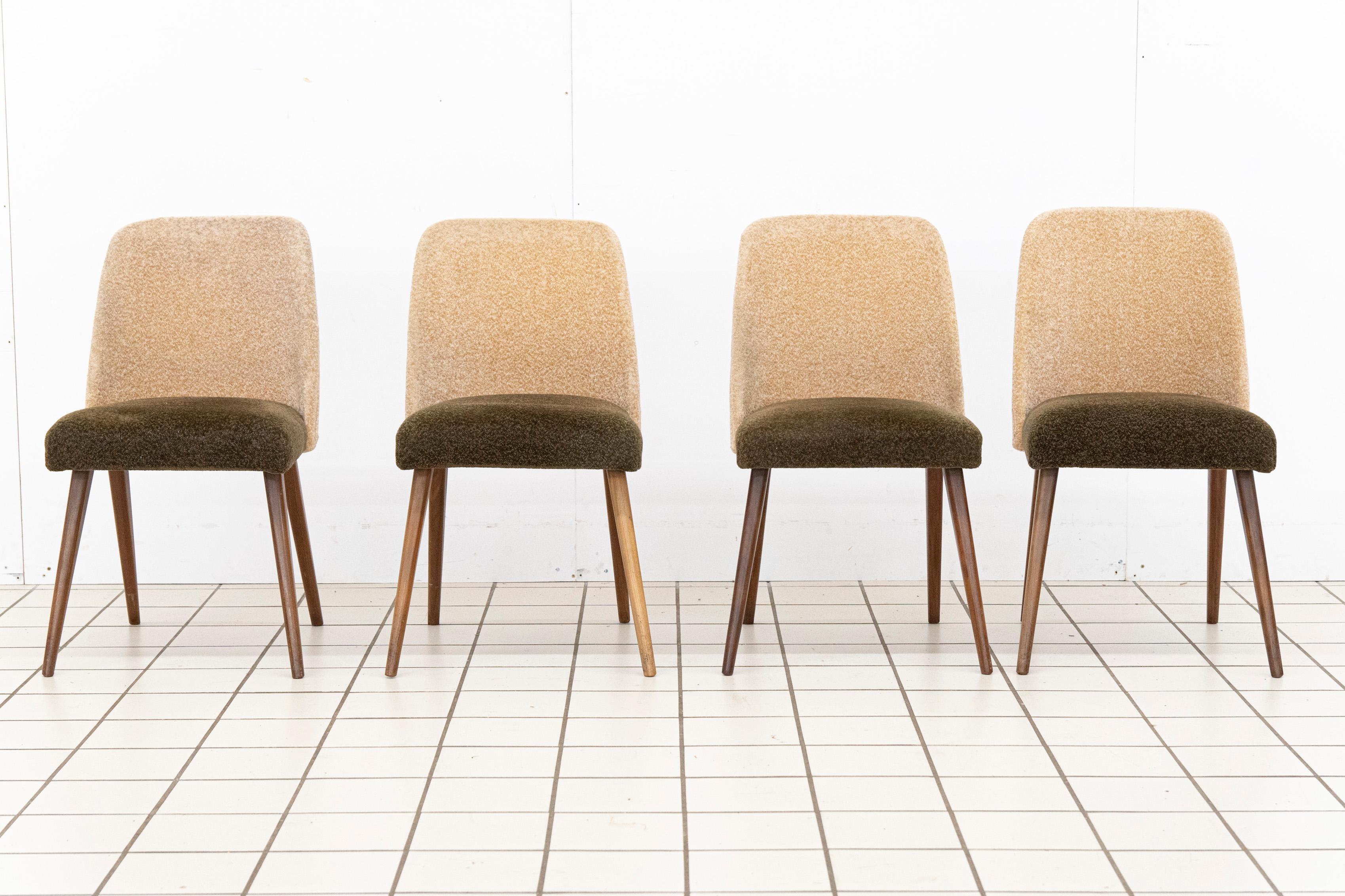 Elegant duo-tone dining room chairs with mid-century modern style. The back of the upholstery is a soft beige tone, and the seat an olive green.  Wooden, tapered legs. These chairs are a versatile addition to both modern and classic