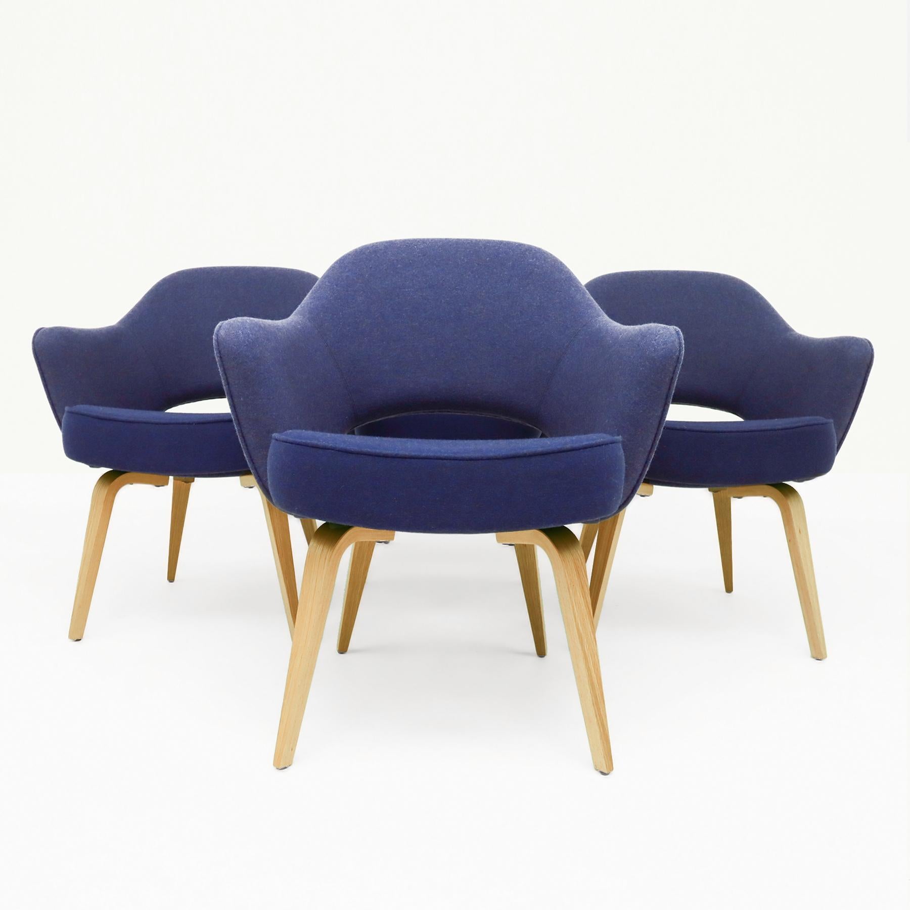 A classic set of 4 vintage Eero Saarininen Knoll Inc. executive armchairs in the original Knoll blue fabric with an oak frame base.

The Eero Saarinen Executive armchair was featured in nearly every Florence Knoll Mid Century interior throughout the