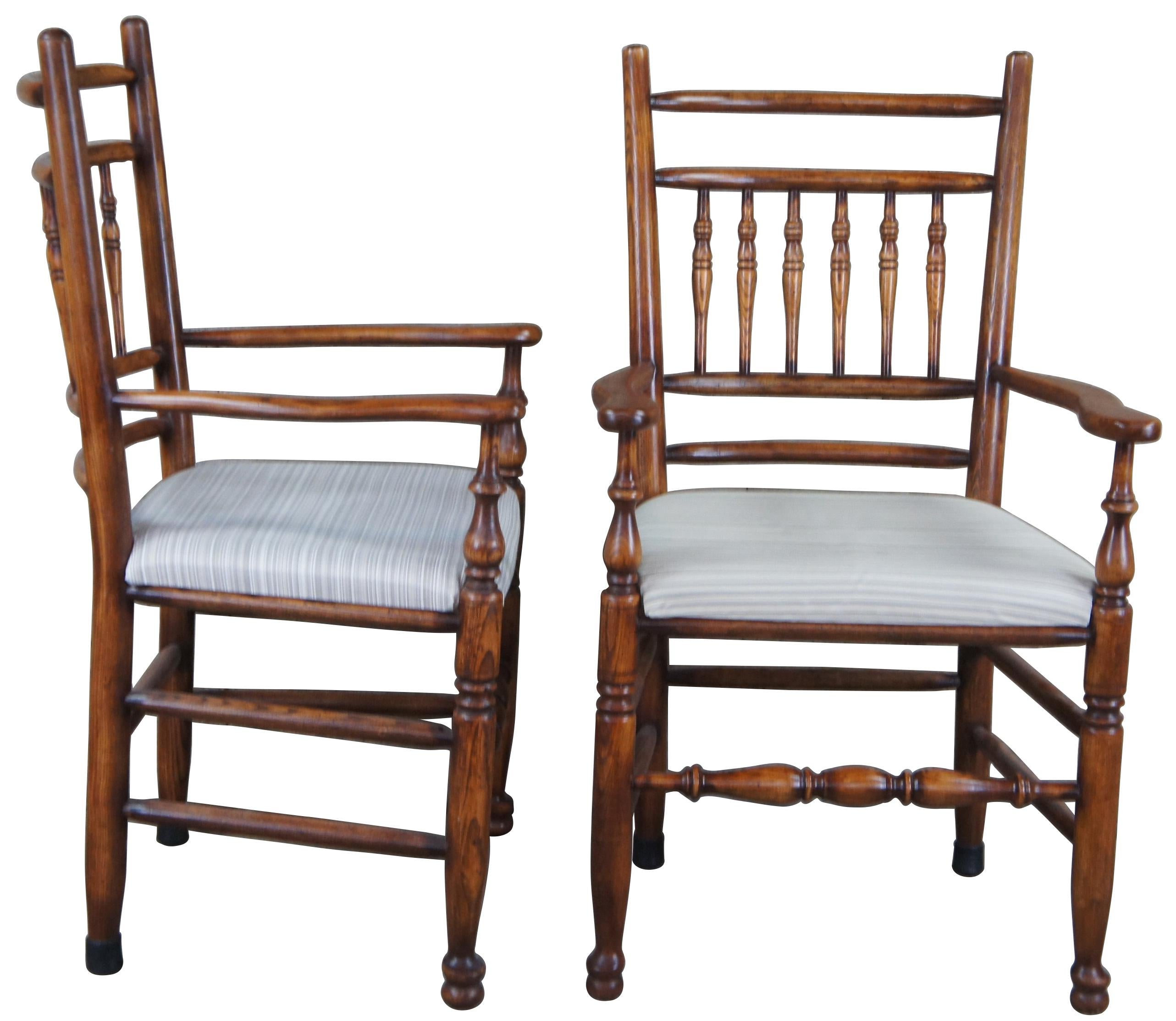 Set of four circa 1980s English Country or Lancashire style arm chairs. Made of oak featuring a spindle back and turned supports.