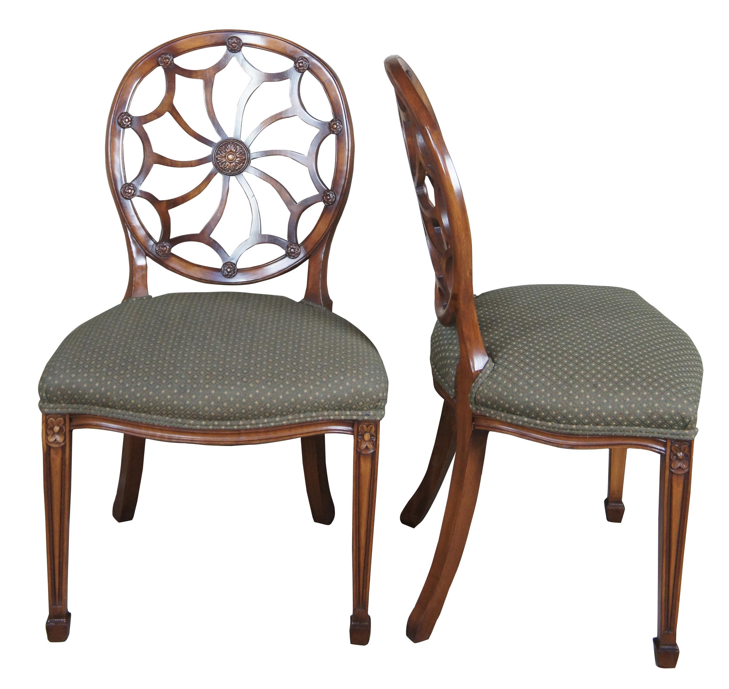 Four late 20th century wheel back dining chairs. Features a balloon shaped back with spidered splat leading to a green seat over a serpentine apron and square tapered legs leading to spade feet.
   