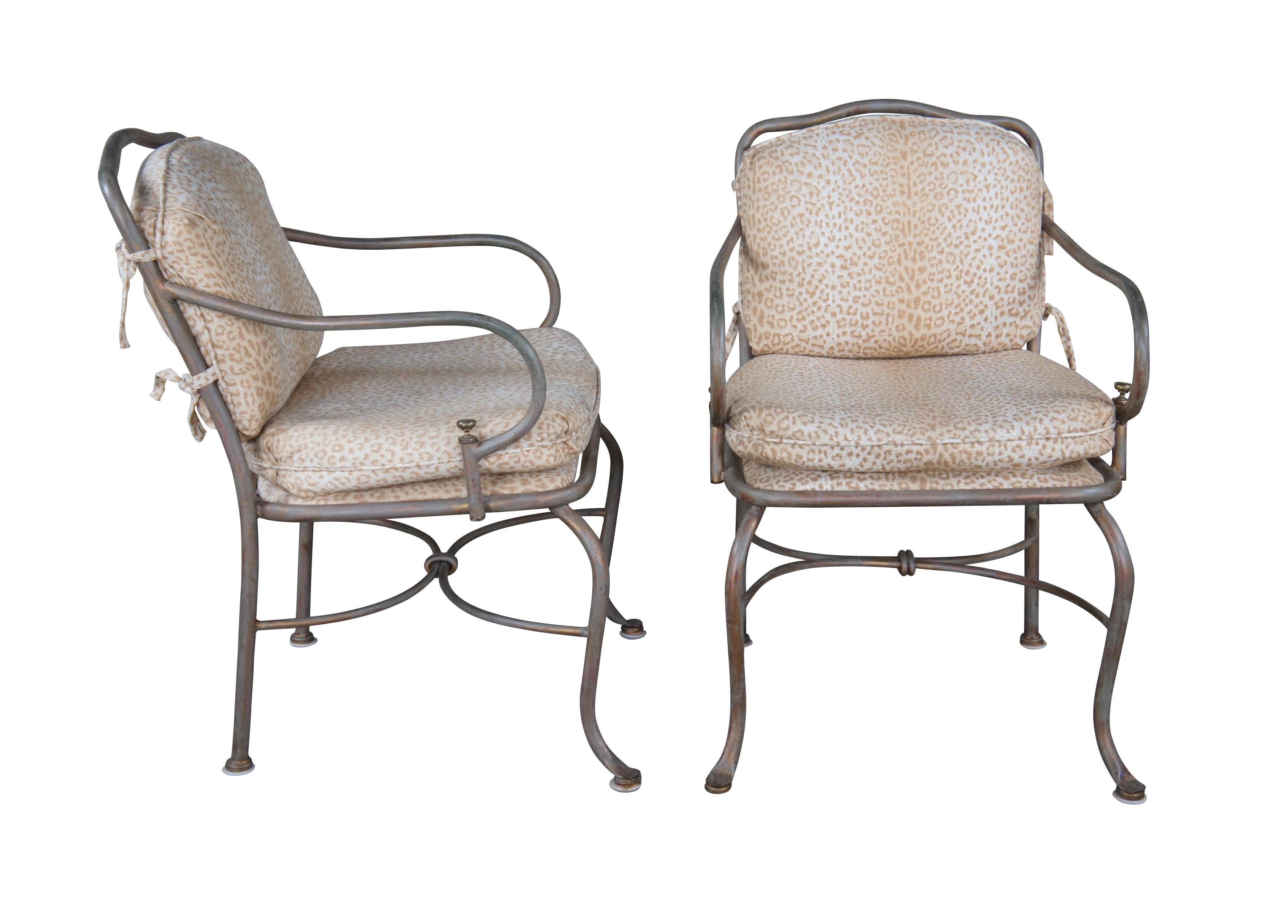 Set of four vintage patio armchairs. Made of iron featuring French styling with serpentine form, leopard print cushions and brass accents.

Dimensions: 
22