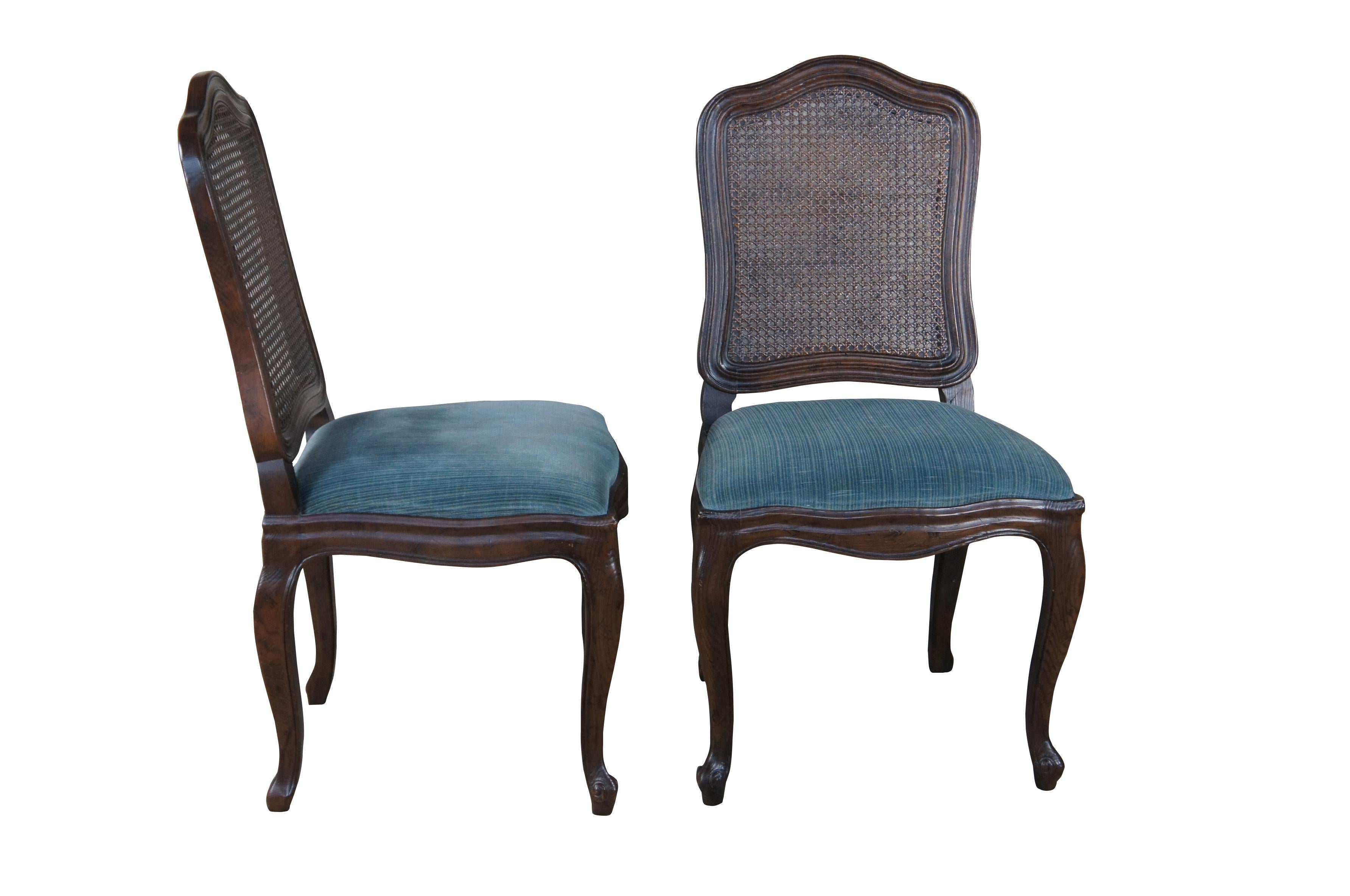 4 Henredon French Country Dining Side Chairs.  Part of the Four Centuries collection, circa 1970s.  Made from oak with a serpentine crest rail and cane back.  Features upholstered seats over cabriole legs and scolled feet.  

DIMENSIONS
20
