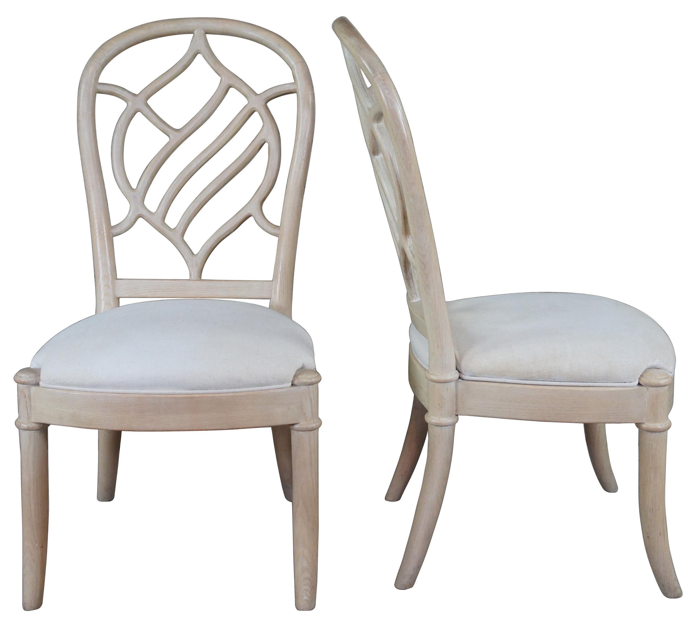 Four vintage Henredon side chairs. Made of pickled oak featuring a sculpted leaf shaped back and upholstered seat.
 