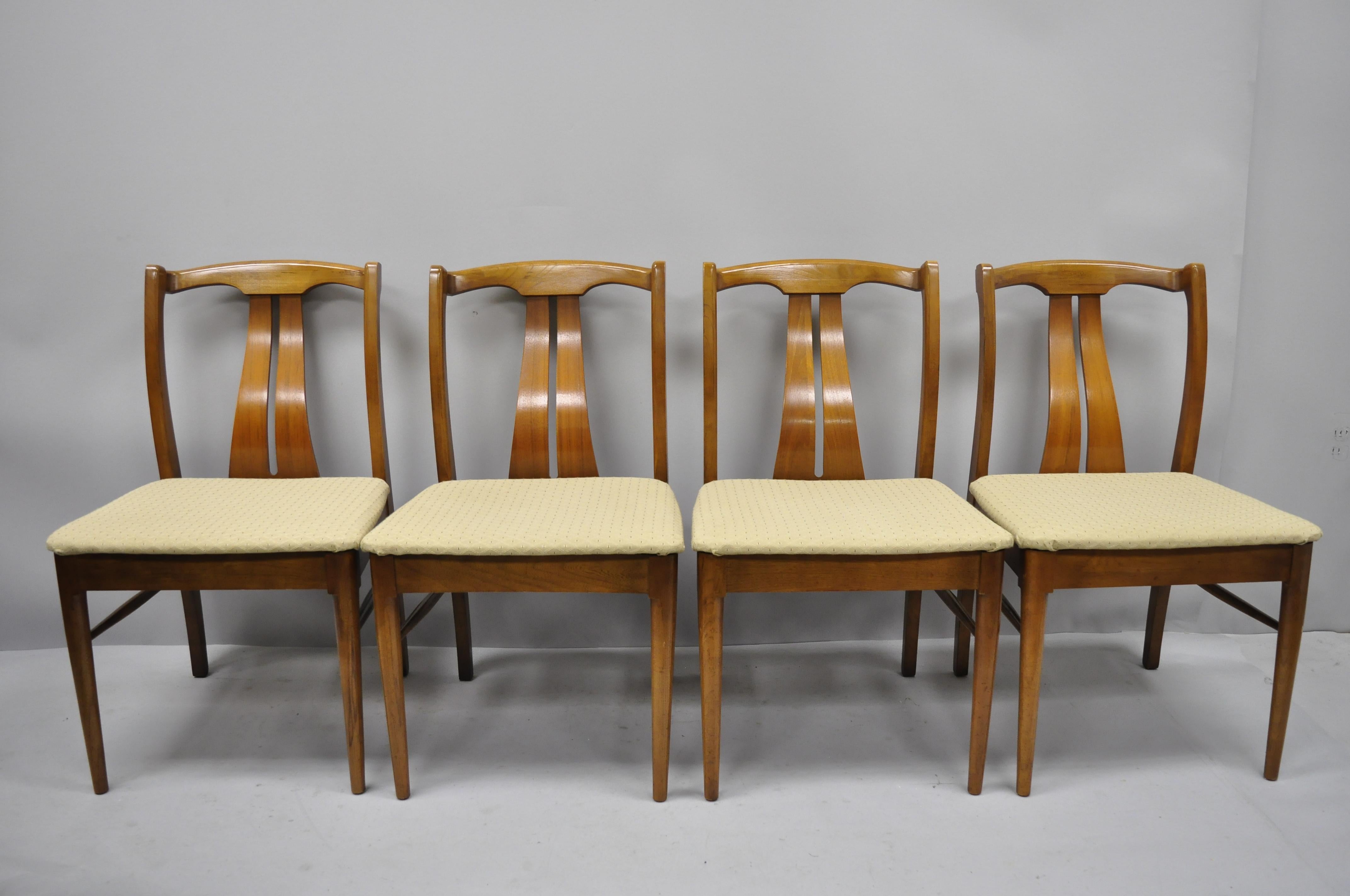 4 vintage Mid-Century Modern curved back sculpted walnut dining chairs listing features solid wood construction, beautiful wood grain, tapered legs, & sleek sculptural form, circa mid-20th century. Measurements: 33