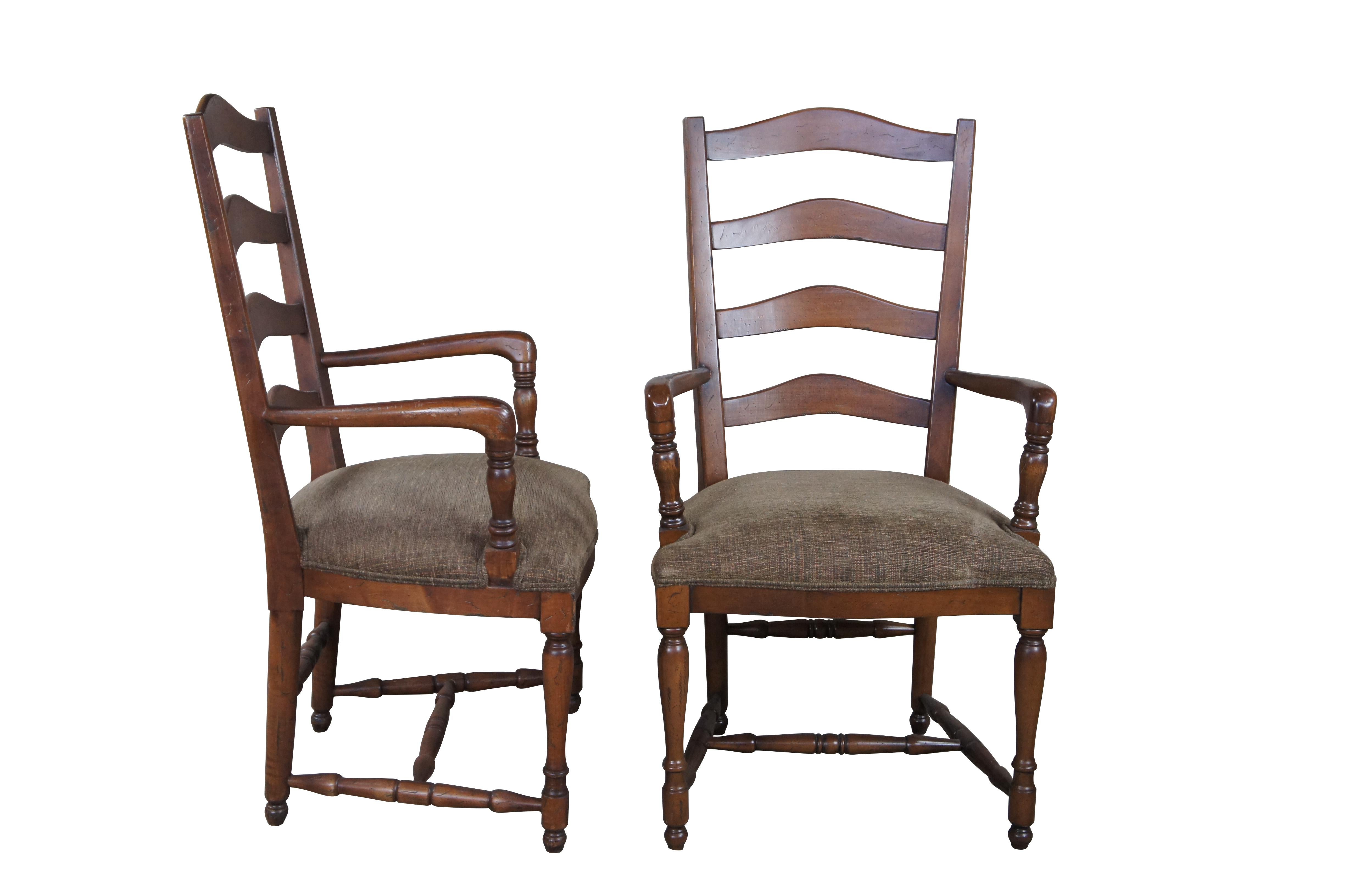4 vintage country French dining chairs, circa late 20th century.  Attributed to Guy Chaddock.  Features a distressed oak frame with ladderback, leading to pronounced arms over an upholstered seat and turned legs with an H stretcher and turnip