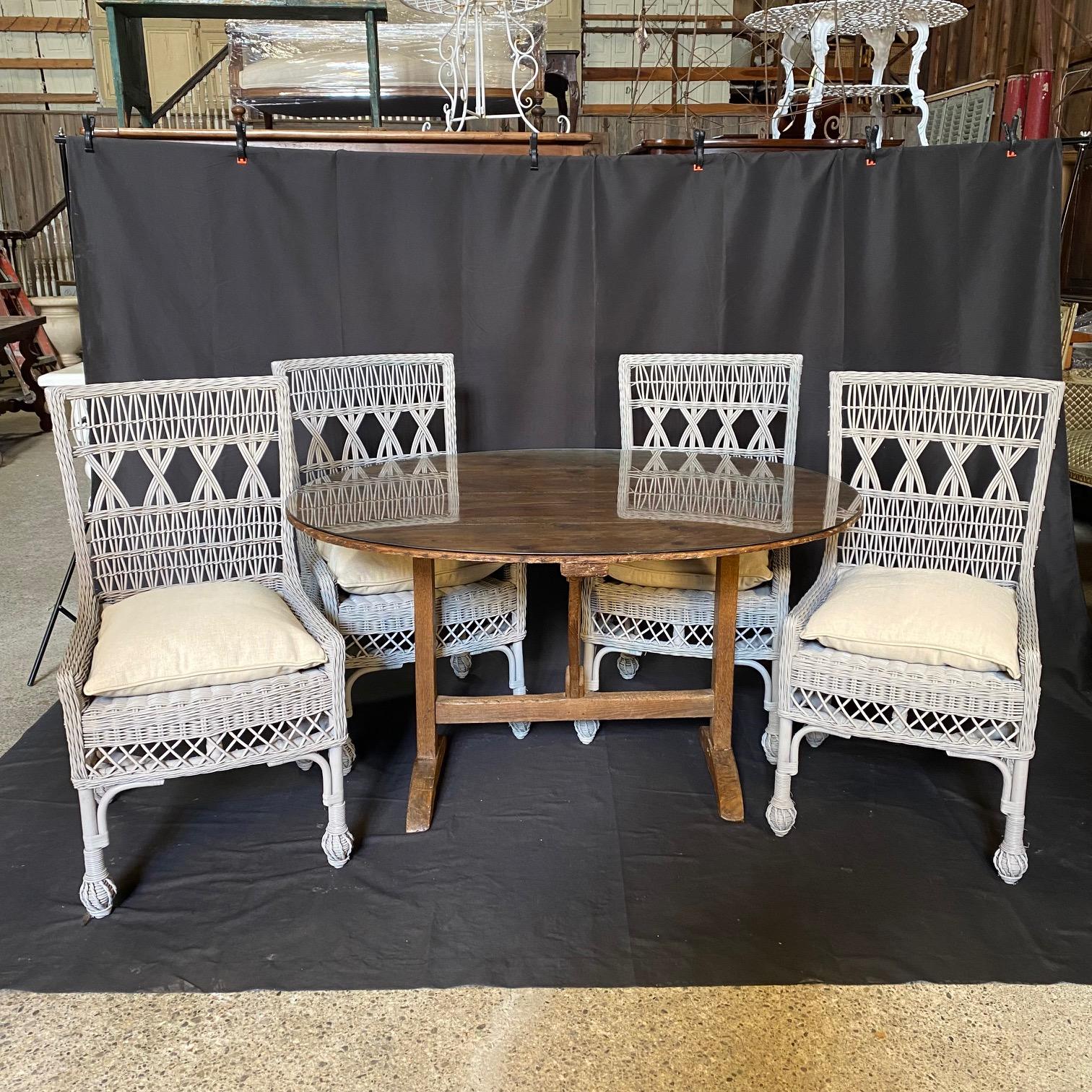 Set of four vintage open weave wicker and bamboo dining chairs or side chairs with newly upholstered neutral gray beige wrapped down seat cushions. Intricate and lovely open classic pattern on seat back, all in great condition! Would make lovely