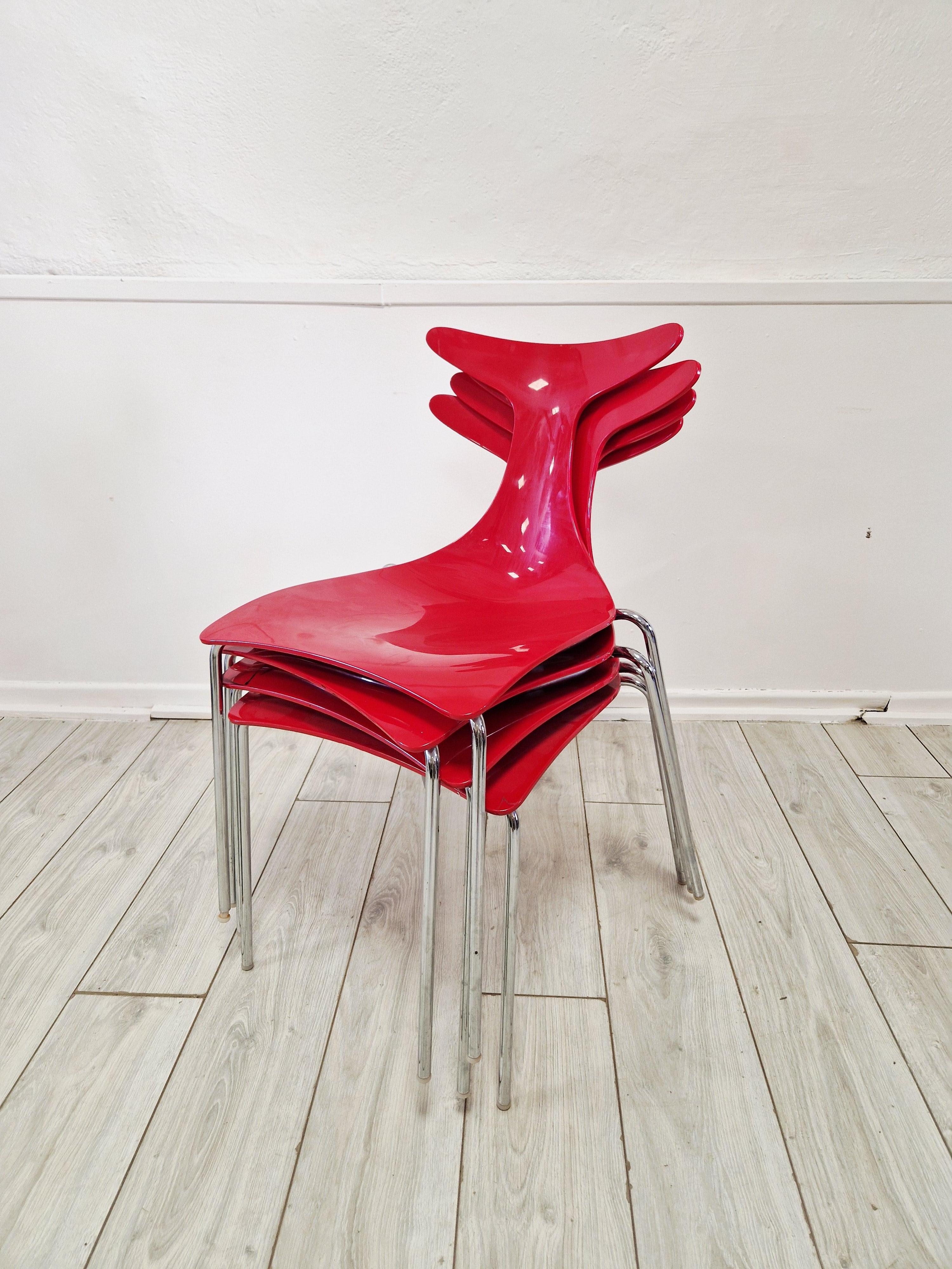 These vintage stacking chairs by Gino Carollo are a charming addition to any room, featuring a square shape and a classic red colour with a vinyl plastic material. The chairs are fully assembled and handmade, with a seat height of 45 cm and an item