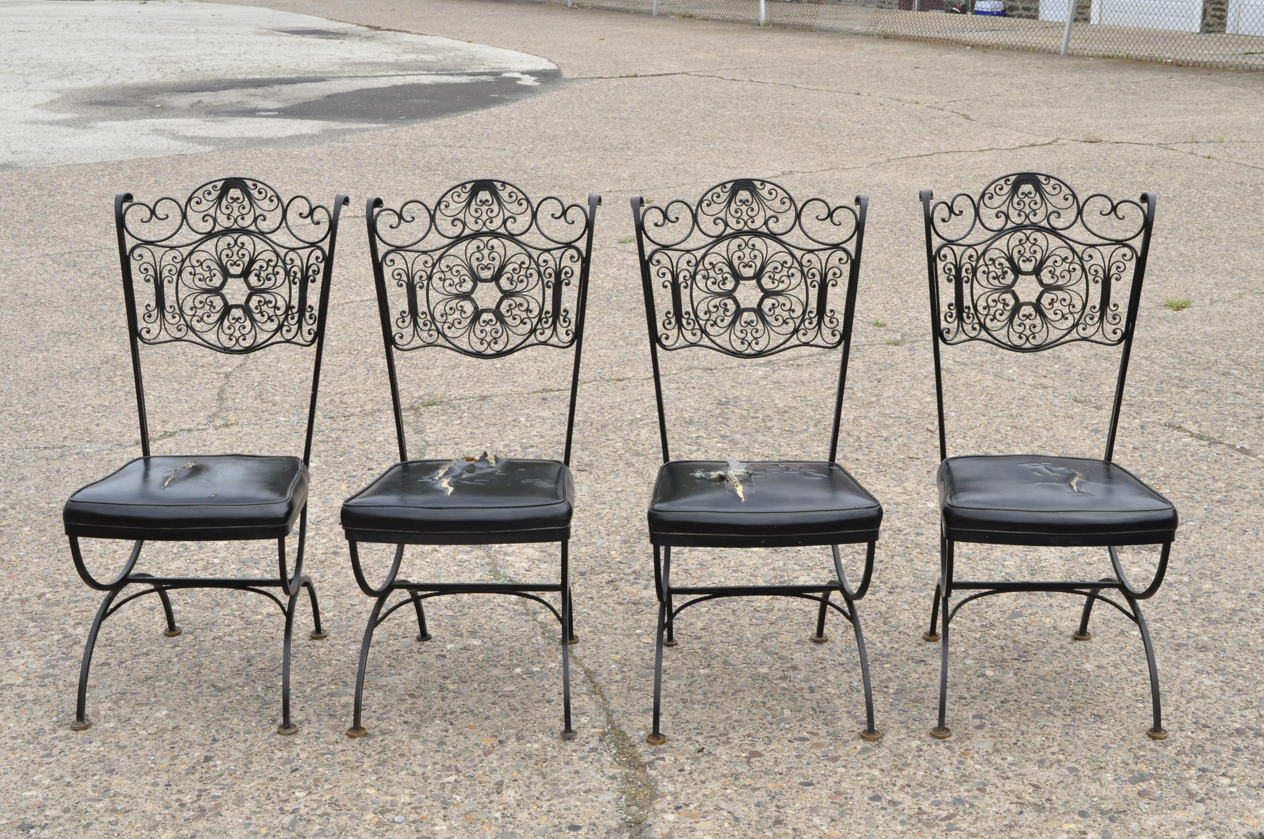 Set of 4 vintage Woodard Andalusian style wrought iron dining chairs by Contempo Frames. Items feature fancy scrollwork backs, Curule stretcher base, wrought iron construction, original label, quality American craftsmanship, great style and form,