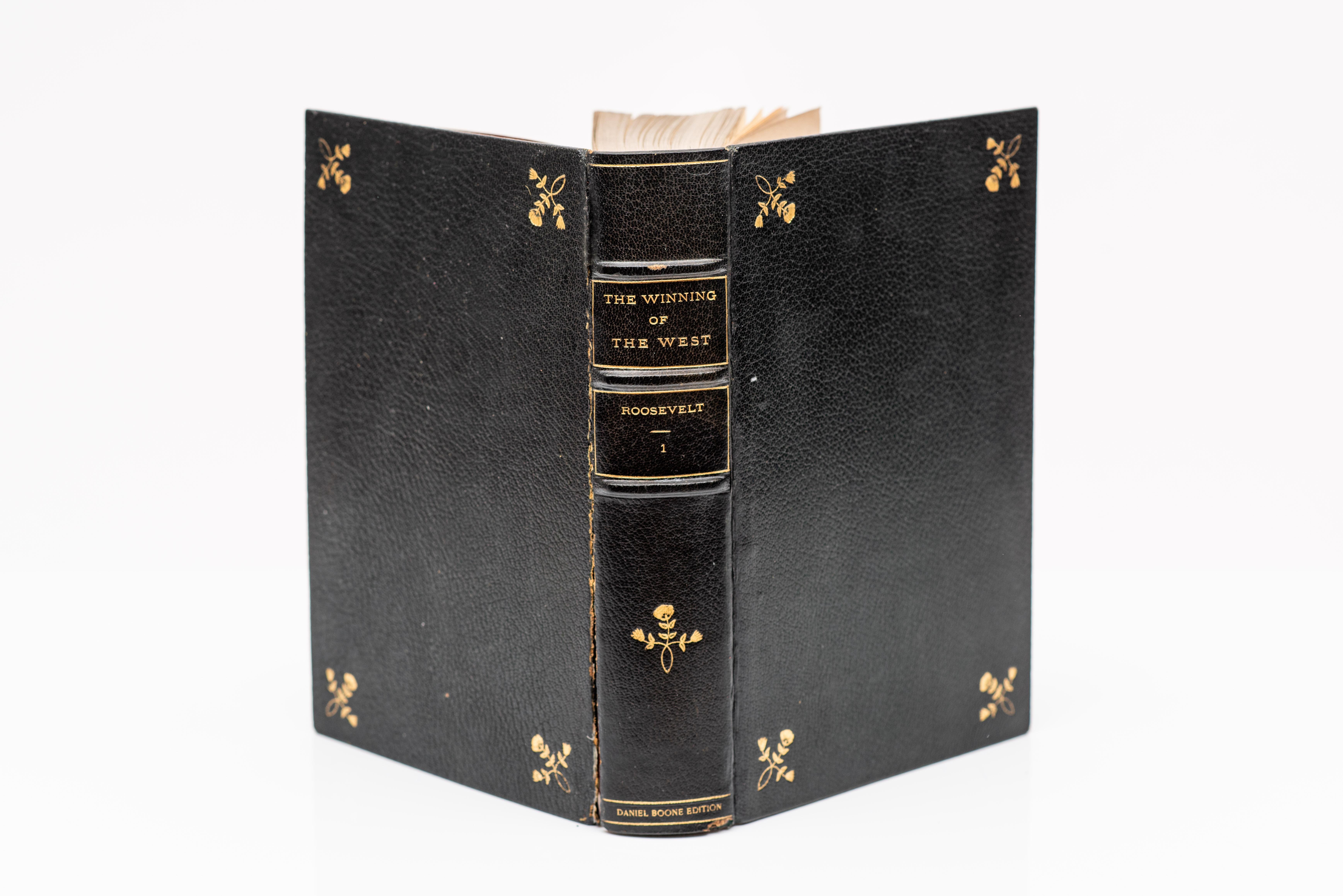 4 Volumes. Theodore Roosevelt, The Winning of the West. Daniel Boone Edition. Bound in full black morocco with floral gilt-tooling on the covers and raised band spine. Top edges gilt. Gilt dentelles with velvet endpapers. Contains a page of the