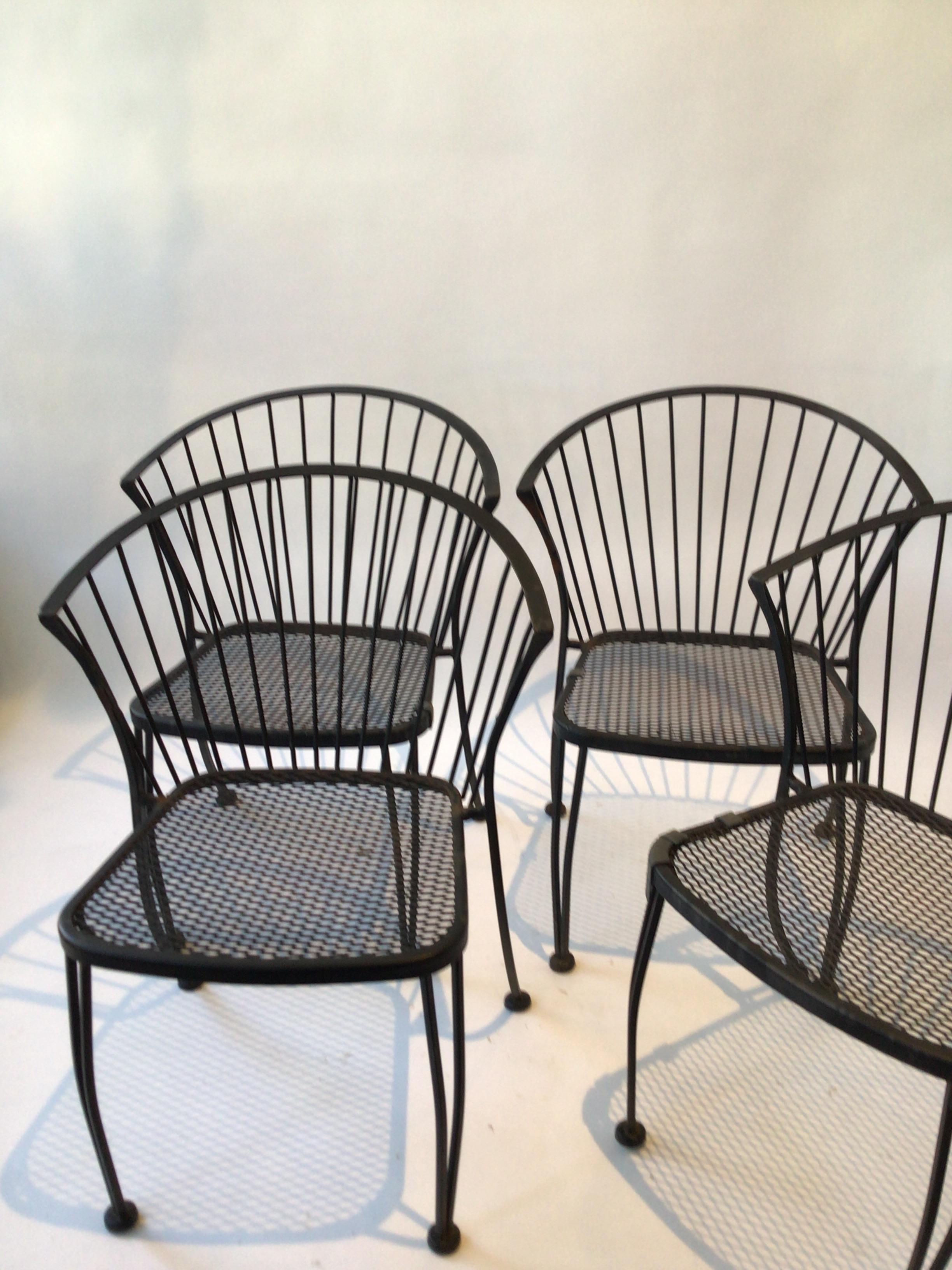 Set of 4 iron garden chairs by Woodard from the 1960s.