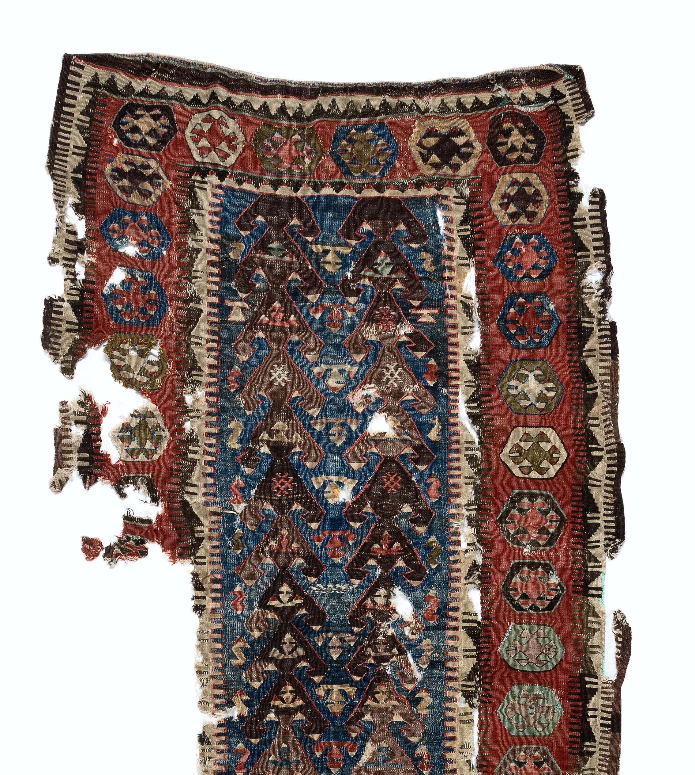 Embark on a journey through time and tradition with this exquisite Antique Turkish fragment distressed kilim, a rare artifact dating back to the 18th century. Crafted with meticulous skill and artistry by Anatolian weavers over three centuries ago,