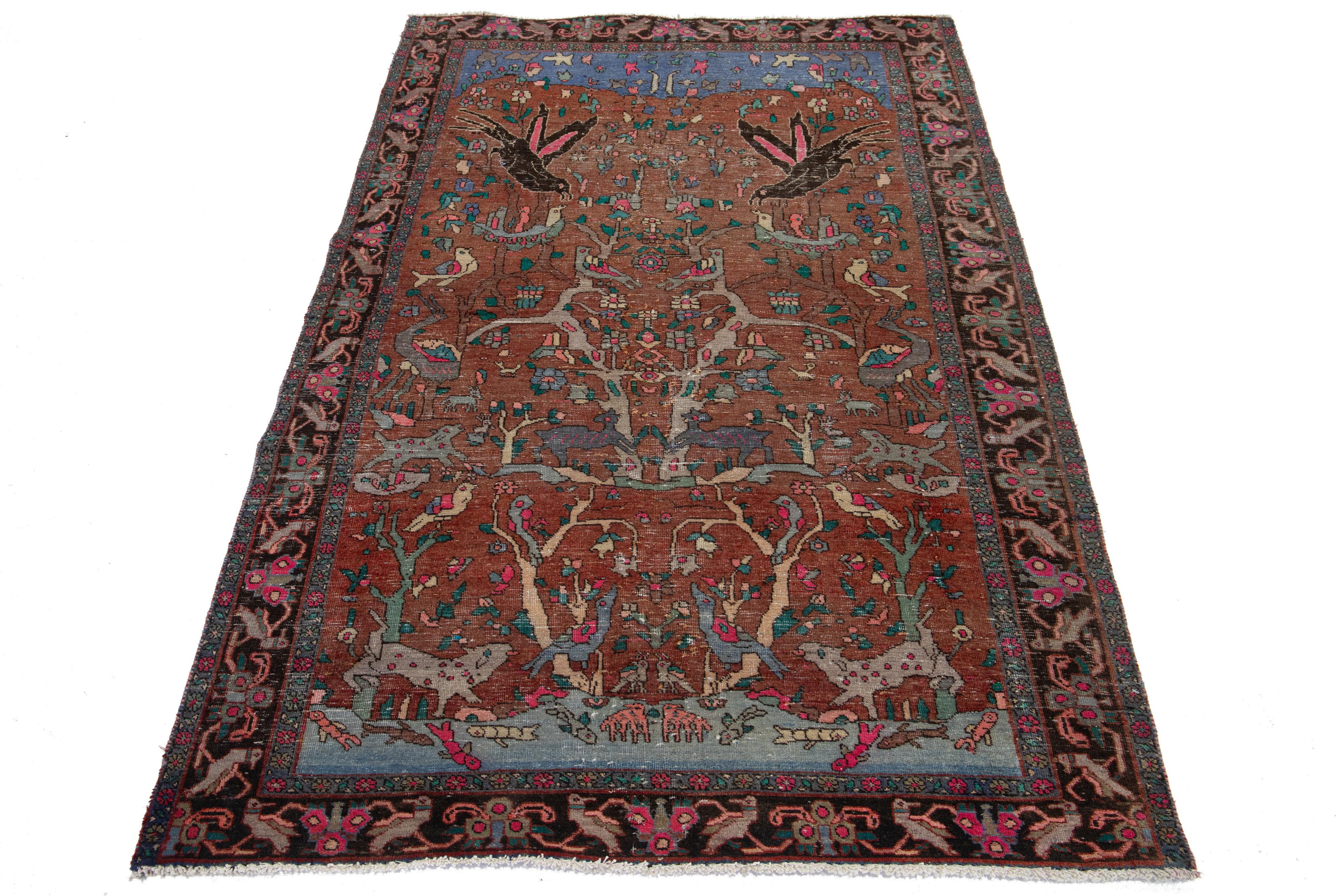 This vintage hand-knotted wool rug features a rust field with multicolor accents throughout the design.


This rug measures 4'4'' x 6'8