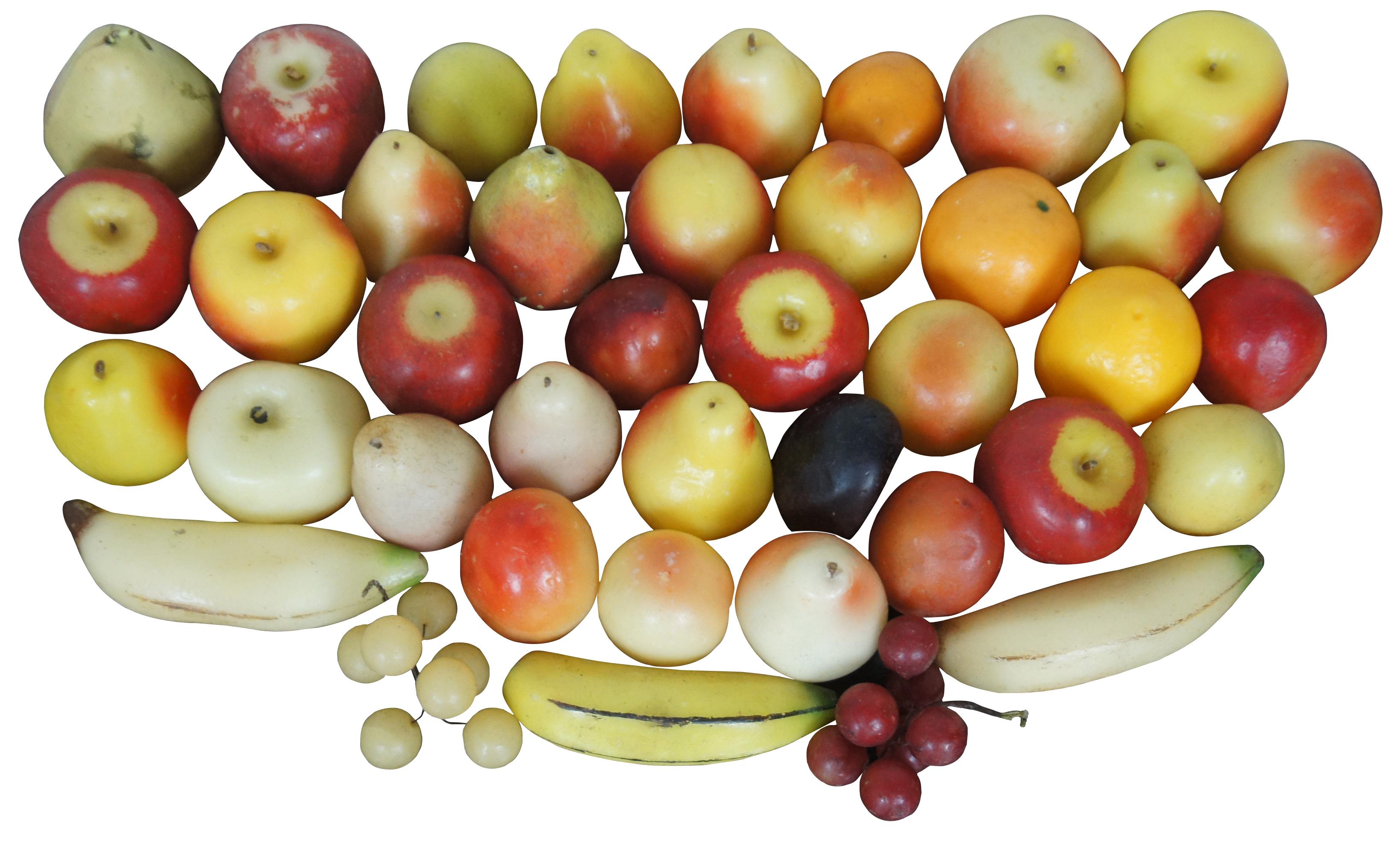 Lot of 40 pieces of wax fruit featuring apples, pears, peaches, oranges, bananas and grapes. One pear is plastic covered polystyrene.

Apple - 3.25” x 3.25” x 3” (Width x Depth x Height).