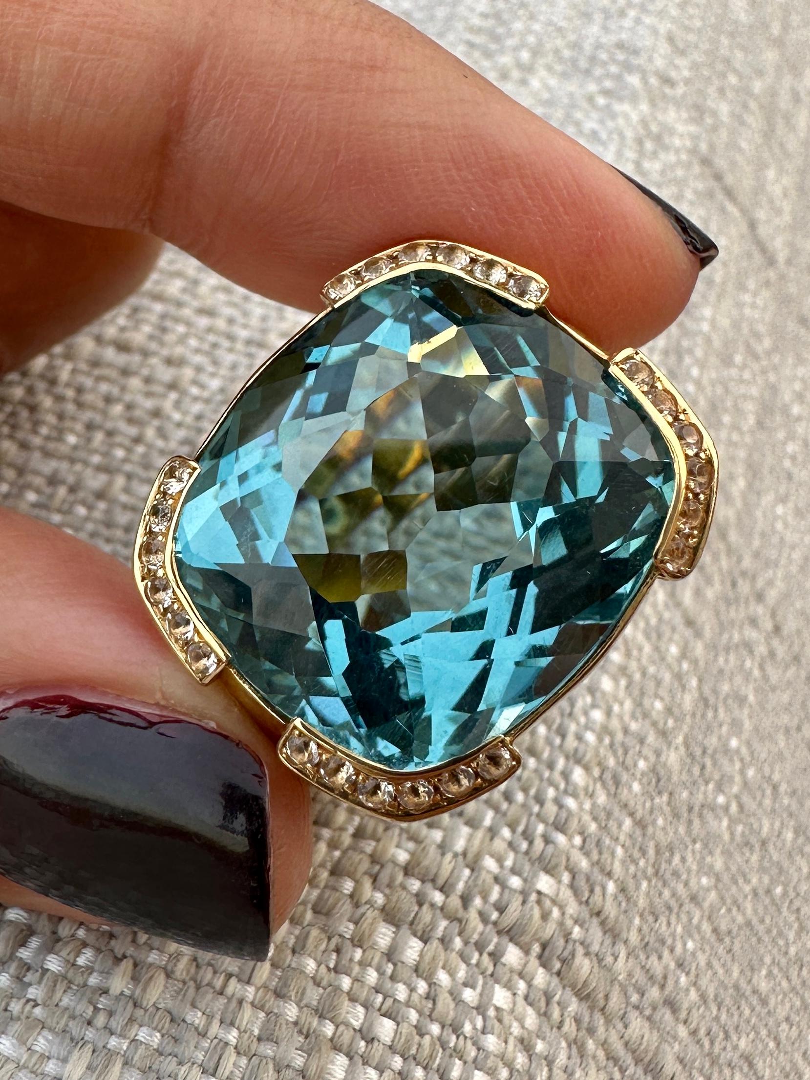 Circa 1970, 19.2K Gold Portuguese Ring. These gorgeous seventies Ring is Set with a Massive Deep Blue 40 Carats Aquamarine framed by 24 white Diamonds totaling 1.92 Carats ( G - H Color, VS - SI1 Clarity).
Is Style Sophisticated look create a sleek
