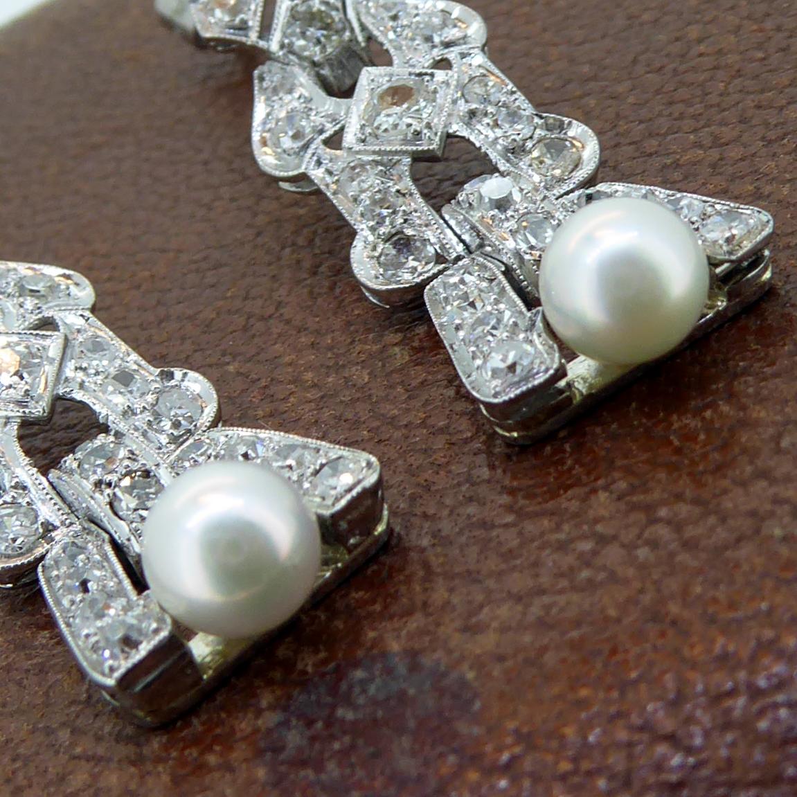 Absolutely gorgeous art deco diamond and pearl drop earrings.  In an open work design of three sections, the earrings are each set to the bottom section with an Akoya cultured pearl, measuring approx. 6.0mm diameter each, very light cream in colour