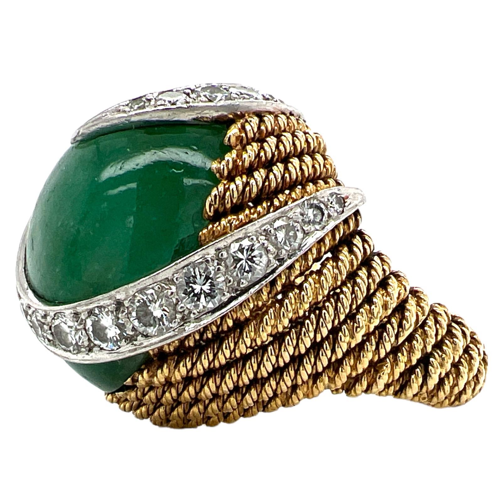 Fabulous emerald diamond cocktail ring makes a statement. The ring features an approximately 40 carat cabochon emerald with a rich green color. Round brilliant cut diamonds are set in platinum weighing approximately 1.50 CTW. The diamonds are grade