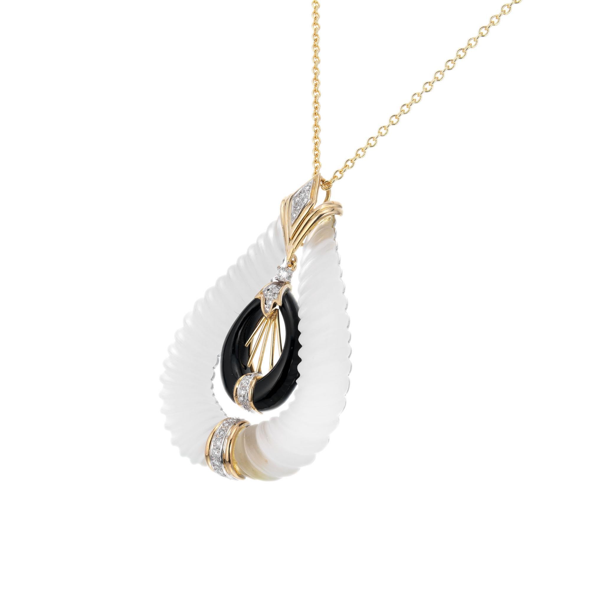 Onyx, diamond and quartz pendant necklace. Set in 14k yellow gold and sterling silver set with frosted quartz, black onyx and 25 accent diamonds on a 14 yellow gold chain. 

25 round brilliant cut diamonds G-H VS-SI, approx. .40ct
14k yellow gold