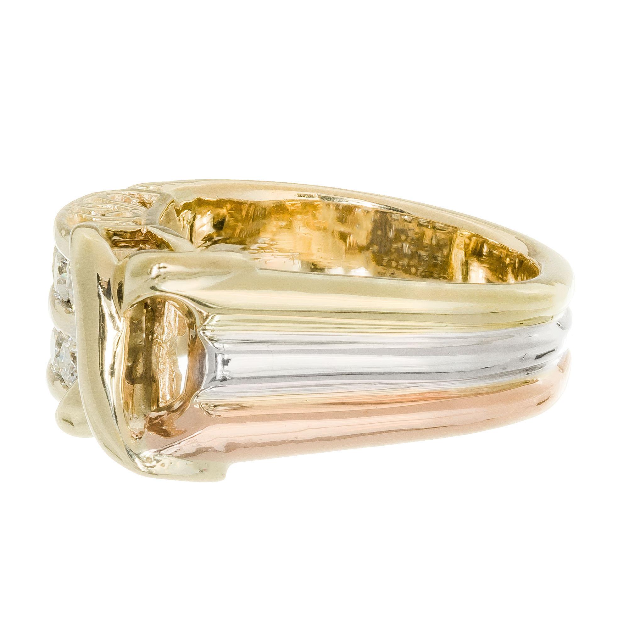 Designer ADE diamond ring.  The shank of the ring has a unique shape.  It is flat on one side and curved on the other.  It is made from three separate bands of gold, rose, white and yellow, 14k.  There is an “X” on the top and then two rows of 8