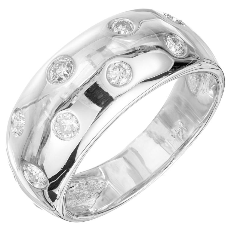 Two row 14k white gold diamond dome band ring. 10 round cut diamonds set in 14k white gold. 

10 round diamonds, G-H VS approx. .40cts
Size 7.25 and sizable 
14k white gold 
Stamped: 14k
5.5 grams
Width at top: 8.7mm
Height at top:3.48mm
Width at
