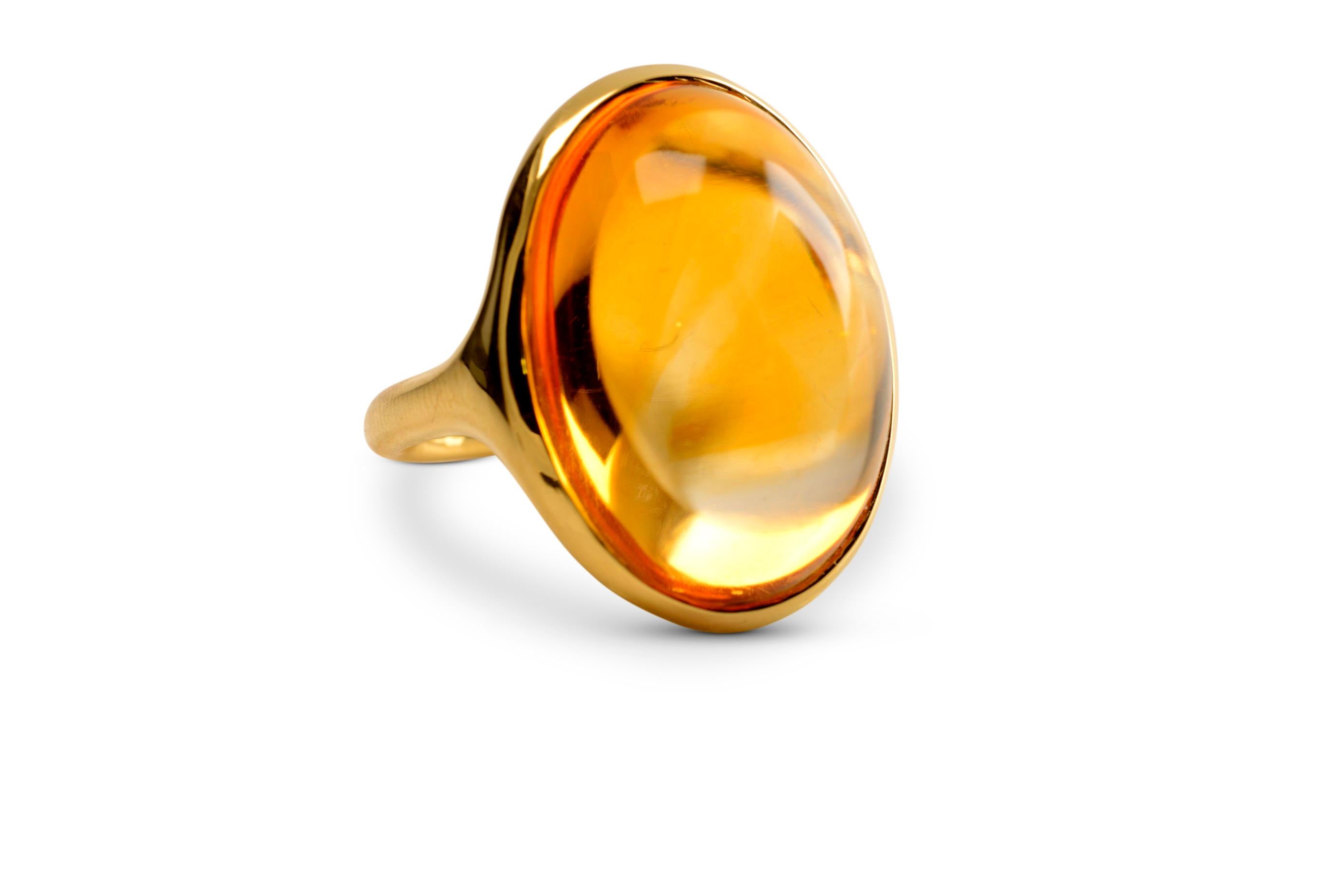 Hand sculpted by Nicky Burles is this sleek contemporary cocktail ring. A sumptuous golden citrine cabochon of 40 carats floats effortless on your hand, seated discreetly in an 18 karat yellow gold band that folds gently around your finger.