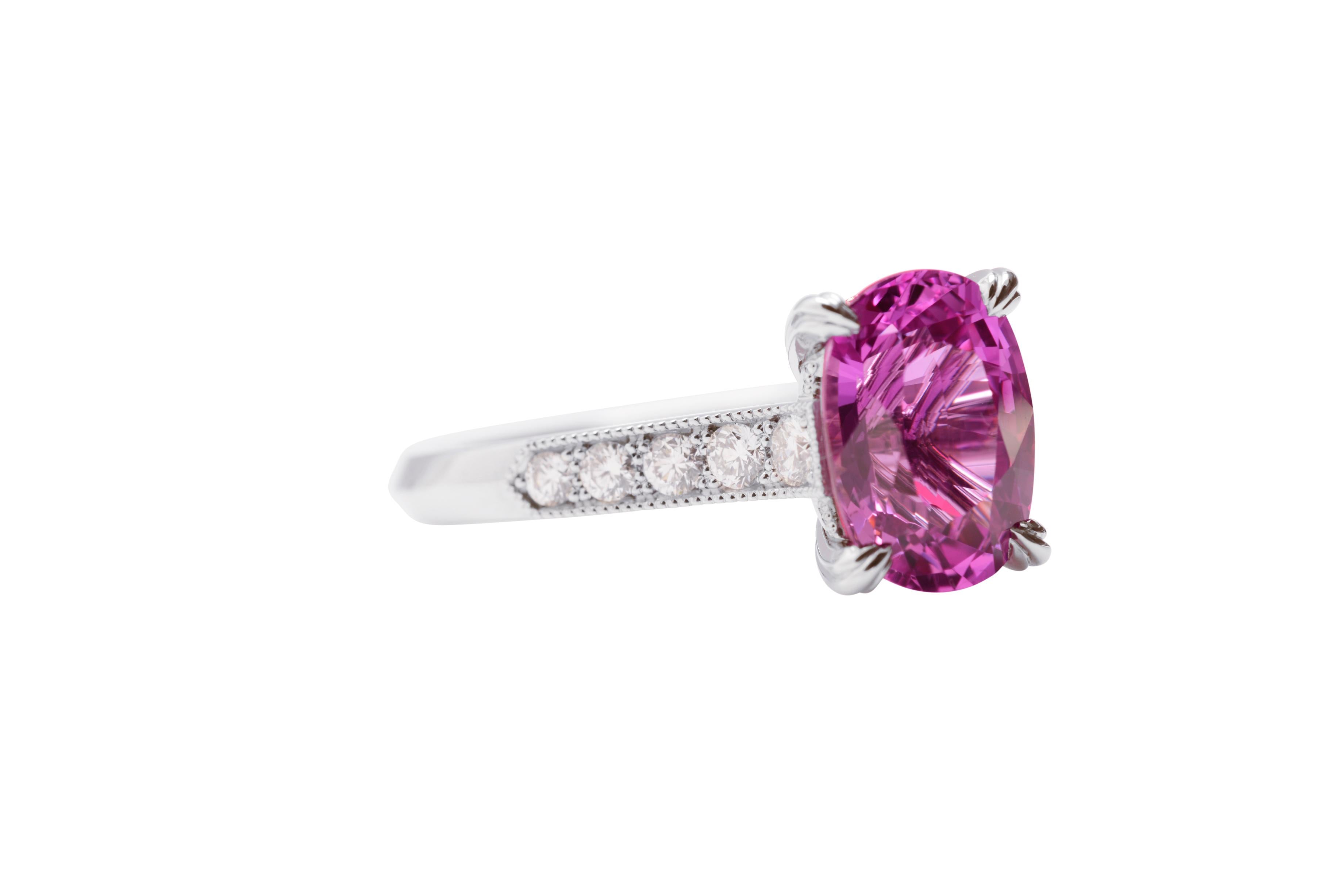 In Nicky Burles signature solitaire design is a 4.0 carat intense pink oval cut sapphire. Handcrafted in platinum the centre setting has four fine triple wire claws, the band softly up swept and detailed with graduating brilliant cut diamonds that