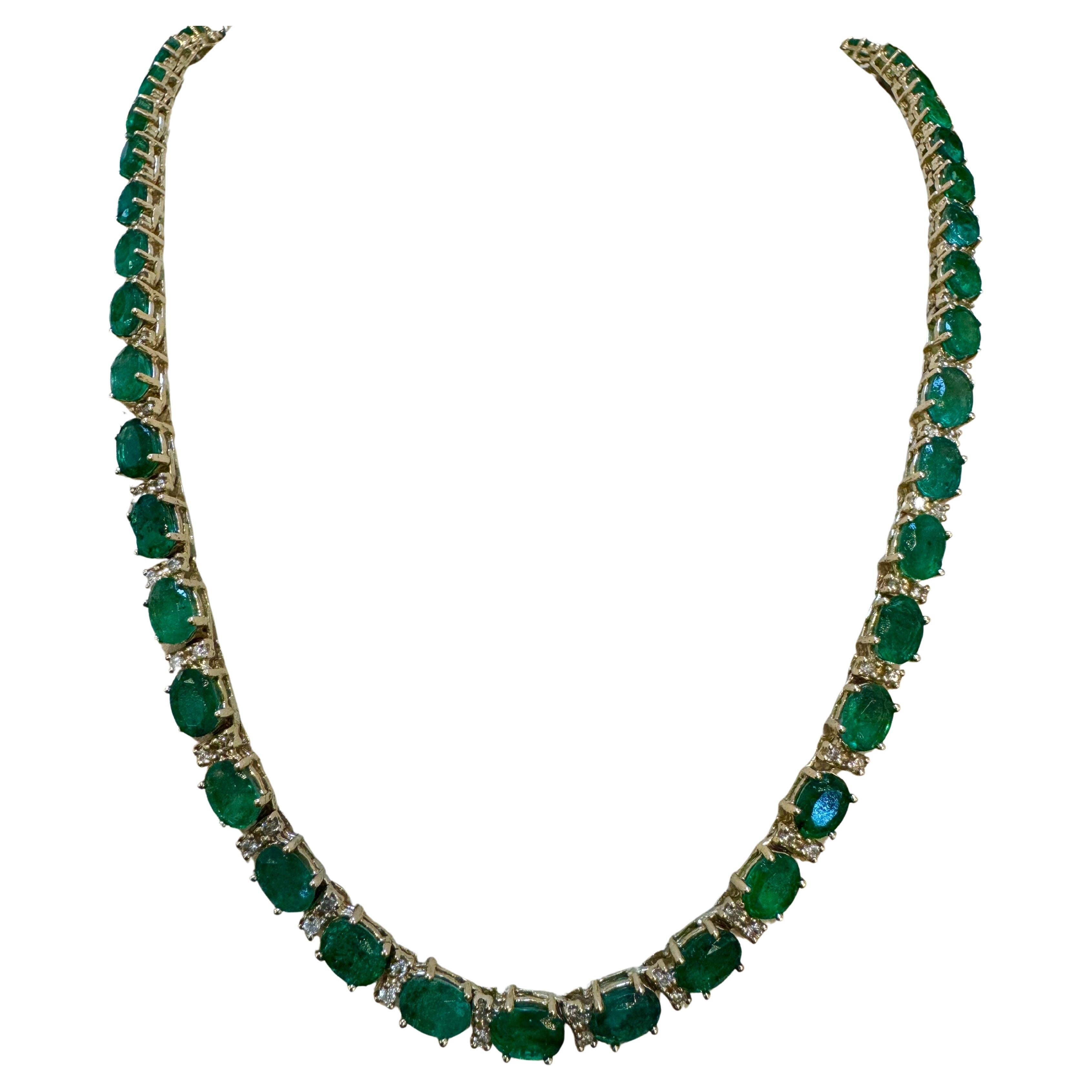 Presenting the exquisite 40 Carat  Oval Brazilian Emerald & 3 Carat Diamond Tennis Necklace in 14 Karat Yellow Gold, measuring 18 inches in length. This stunning piece features 50 emerald stones, each approximately 7X5 in size, ranging from 80 to 90