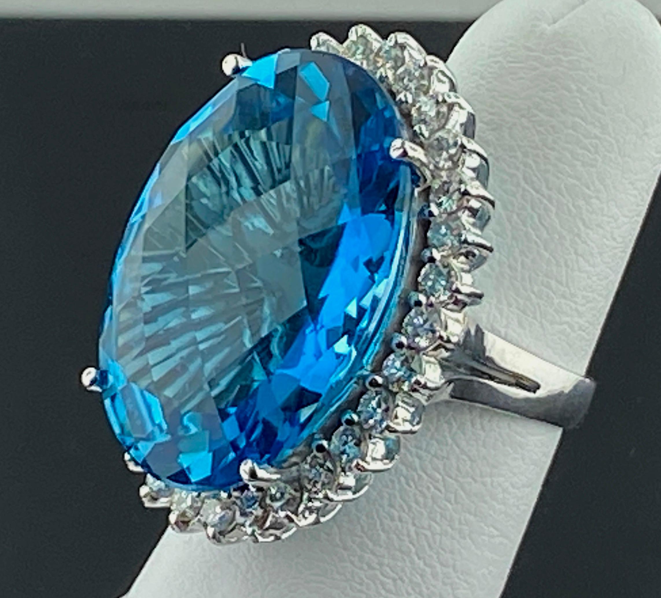 Set in 14 karat white gold, weighing 20 grams, is a beautiful 40 carat Oval Cut London Blue Topaz ring with 30 Round Brilliant Cut diamonds weighing 1.50 carats.  Color: F-G, Clarity: SI-1.  Ring size 6.5.