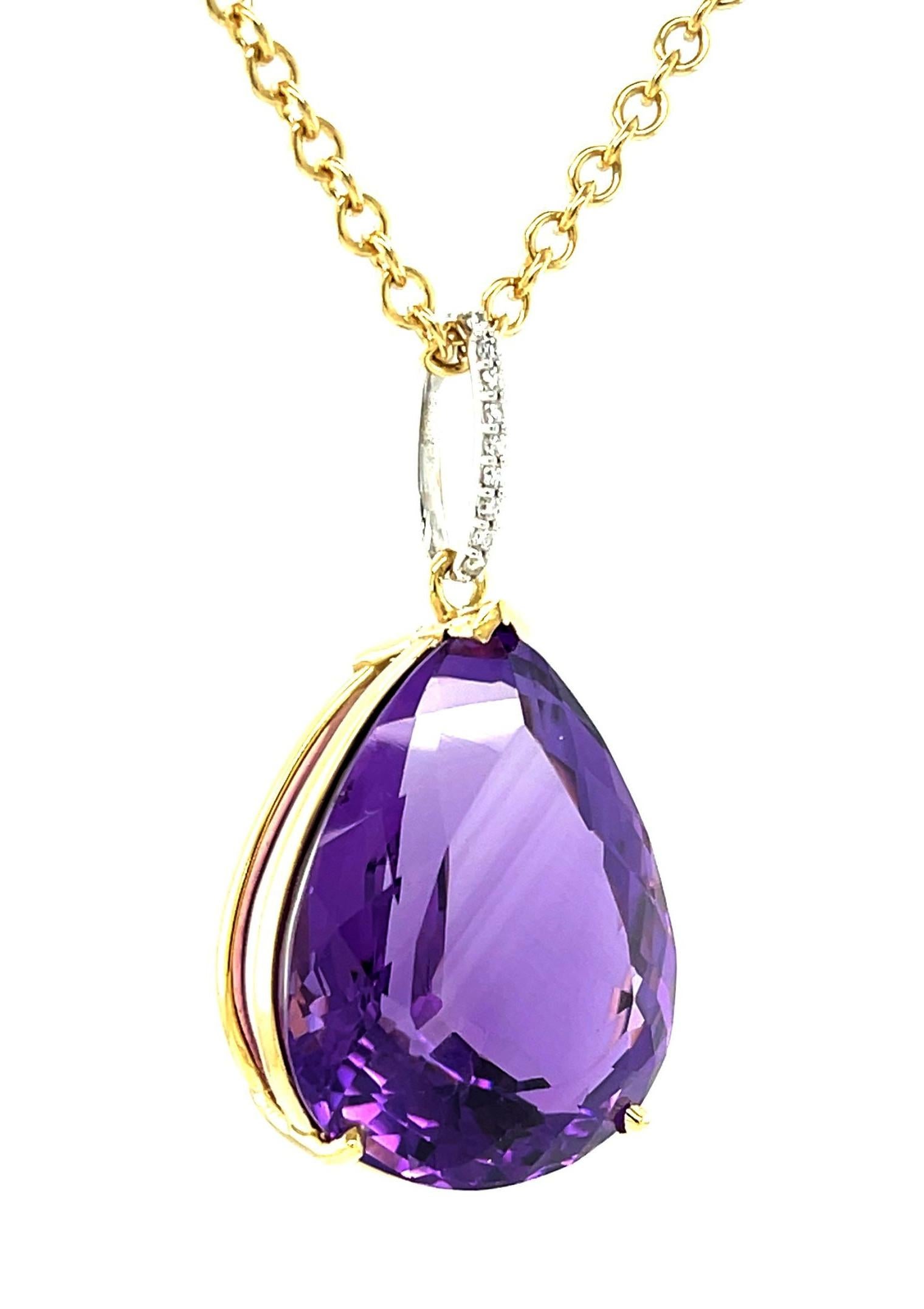 This eye-catching necklace features an impressive and absolutely stunning amethyst that weighs 40 carats! Set in a custom-made 18k yellow gold basket that dangles from an elegant diamond-studded 18k white gold bail, this necklace can be paired with