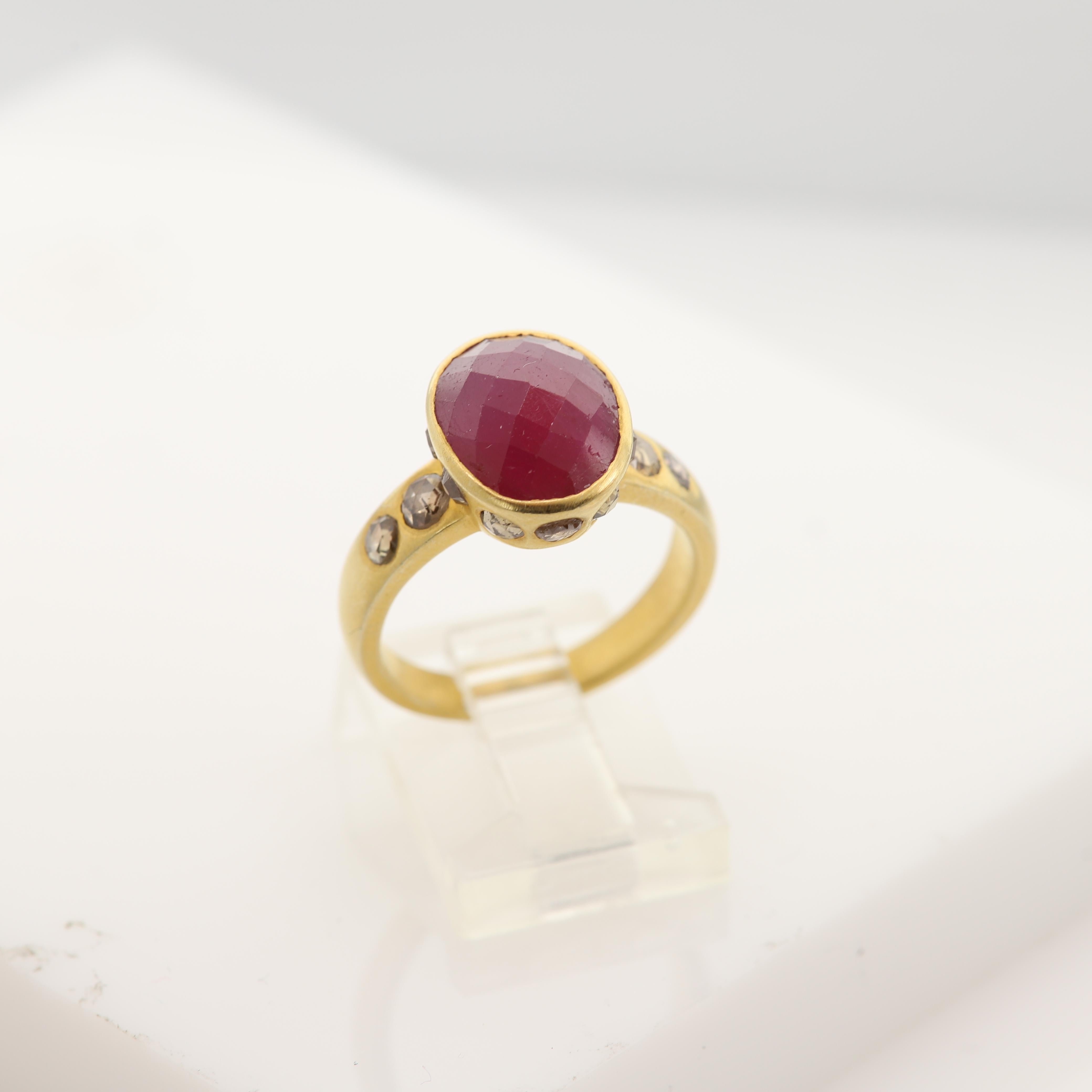 NEW
Vintage Ruby & Diamonds - Hand Made in Italy
18k Yellow Gold 7.0 grams 
Ruby 4.0 Carat Oval shape and checkered cut,  approx size 12 x 10 mm Dark Red Tone & Bezel set
Old Cut Champagne /Light Brown Diamonds on the sides 0.90 carat
Finger size