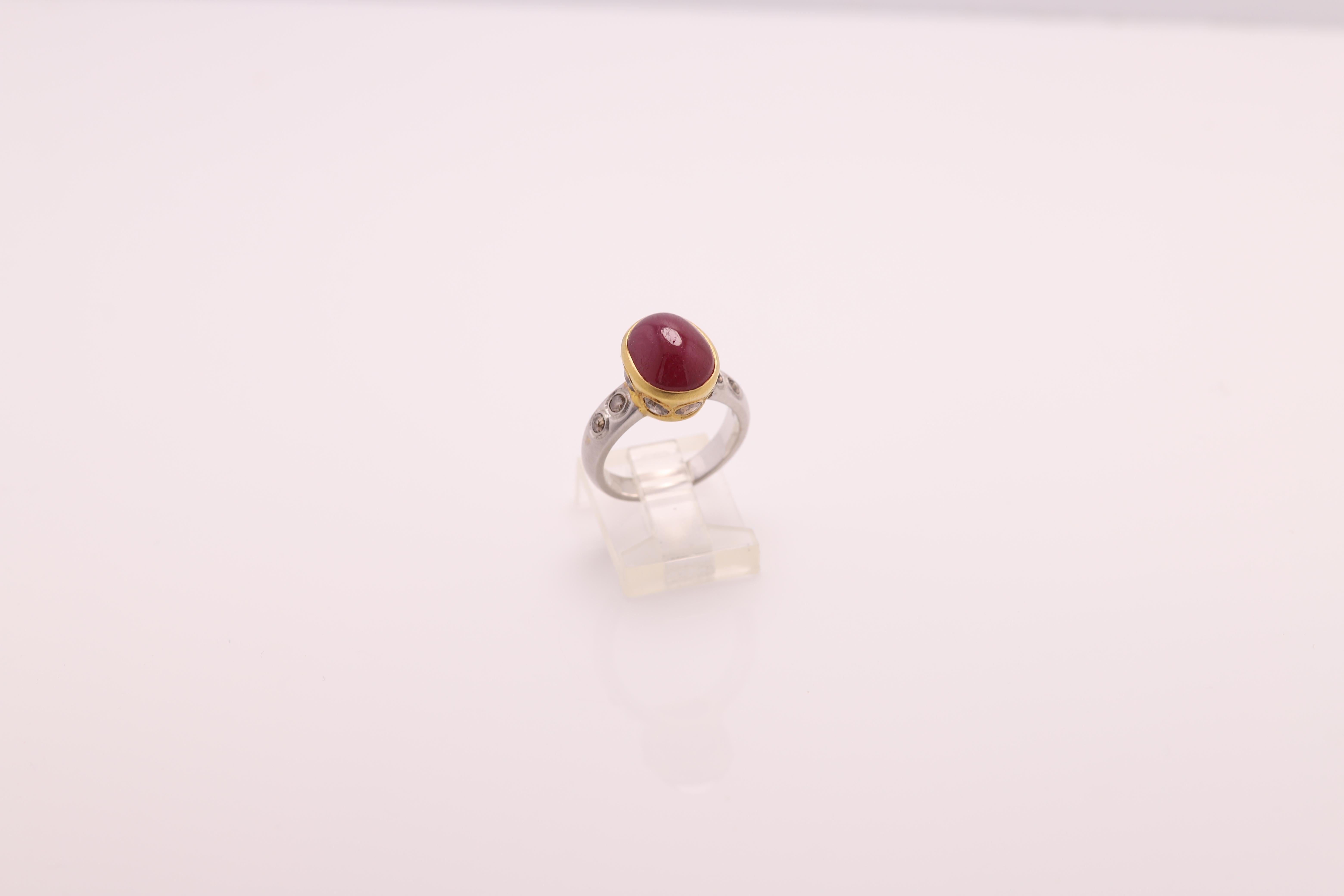 Vintage Ruby & Diamonds - Hand Made in Italy
18k White and Yellow Gold 7.0 grams 
Ruby 4.0 Carat Oval Cabochon shape,  approx size 11 x 9 mm Dark Red Tone & Bezel set
Old Cut Champagne /Light Brown Diamonds on the sides 1.00 carat
Finger size 8
All