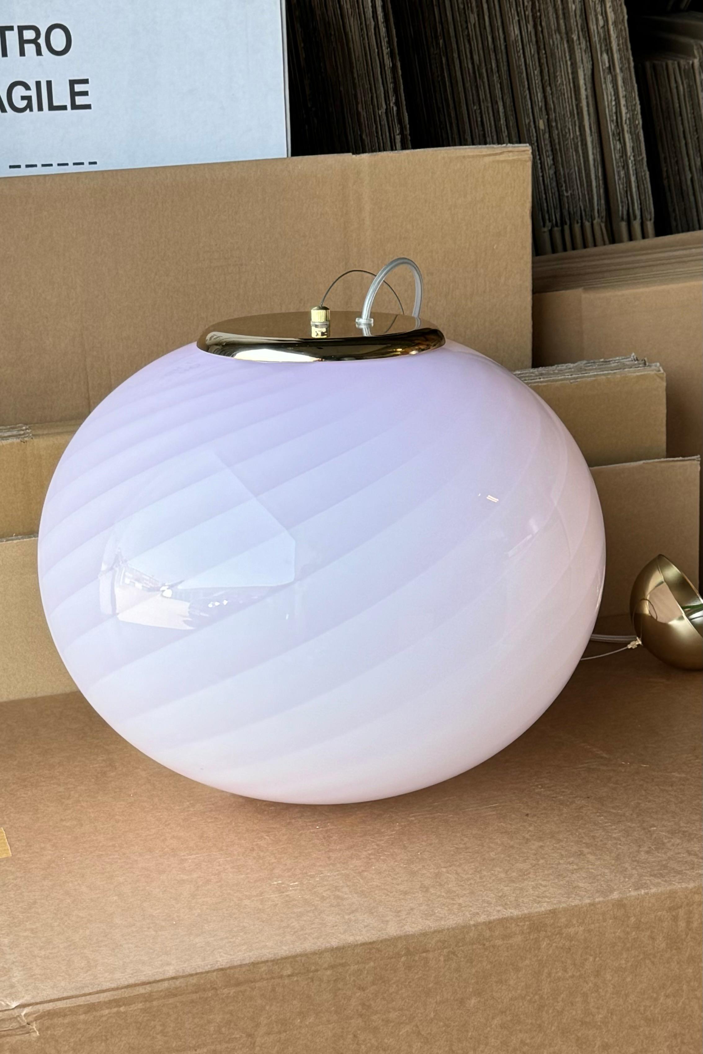 Large new Italian Murano candy pendant ceiling lamp in soft pink. Mouth-blown glass in oval shape with swirl pattern. E27 socket. Comes with adjustable suspension with finish in brass or chrome.
Handmade in Italy.
D:40 cm  

As it is mouth blown