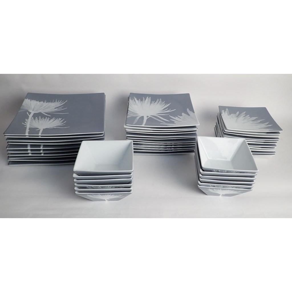 40-piece set of dinnerware CB2 modern featuring mums, 40-piece set. Large set of CB2 dinnerware featuring spider mums in shades of grey with white botanical.
Includes:
10 square 11 3/4