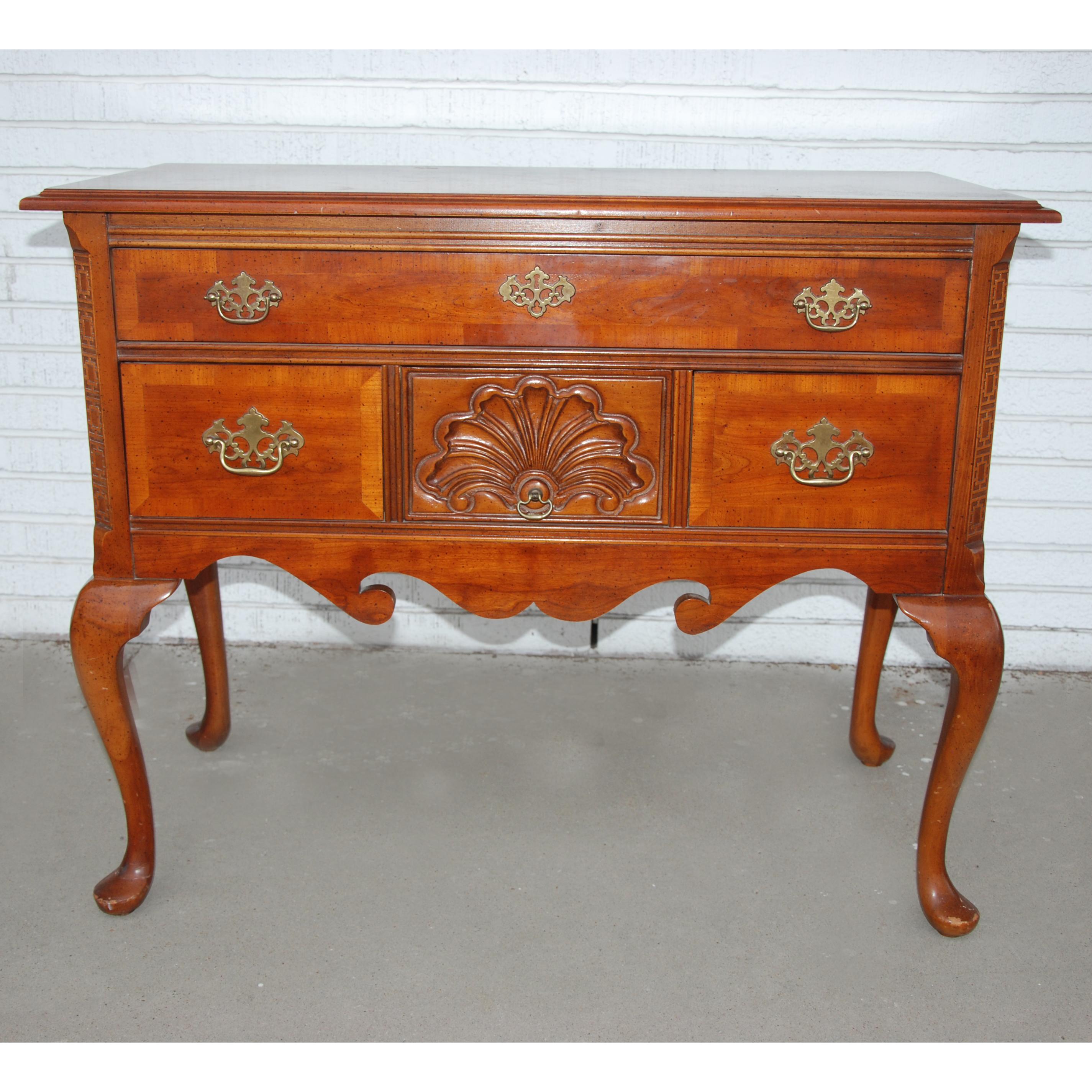 Queen Anne style server credenza from Bassett Furniture

Petite credenza in walnut with traditional Queen Anne embellishments.
Dovetailed drawer construction
Brass hardware
Cabriole legs with pad feet
One top drawer with 3 small underneath